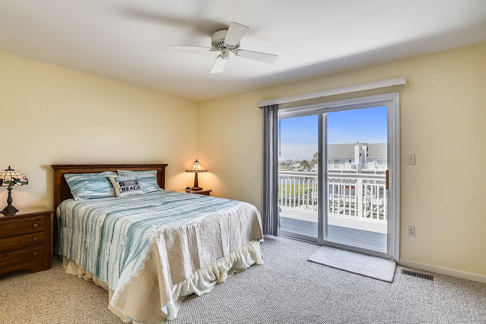 Your bright bedroom opens onto a private balcony overlooking peaceful surroundings—soft breezes and natural light make this your perfect coastal retreat.