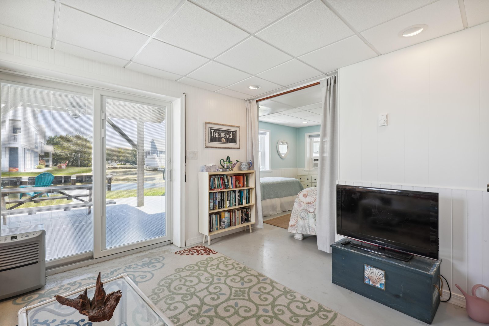 Step into your bright, coastal retreat where soft blues and whites create a serene escape. Glass doors open to your private deck overlooking the neighborhood, inviting sunlight to fill your space all day long.
