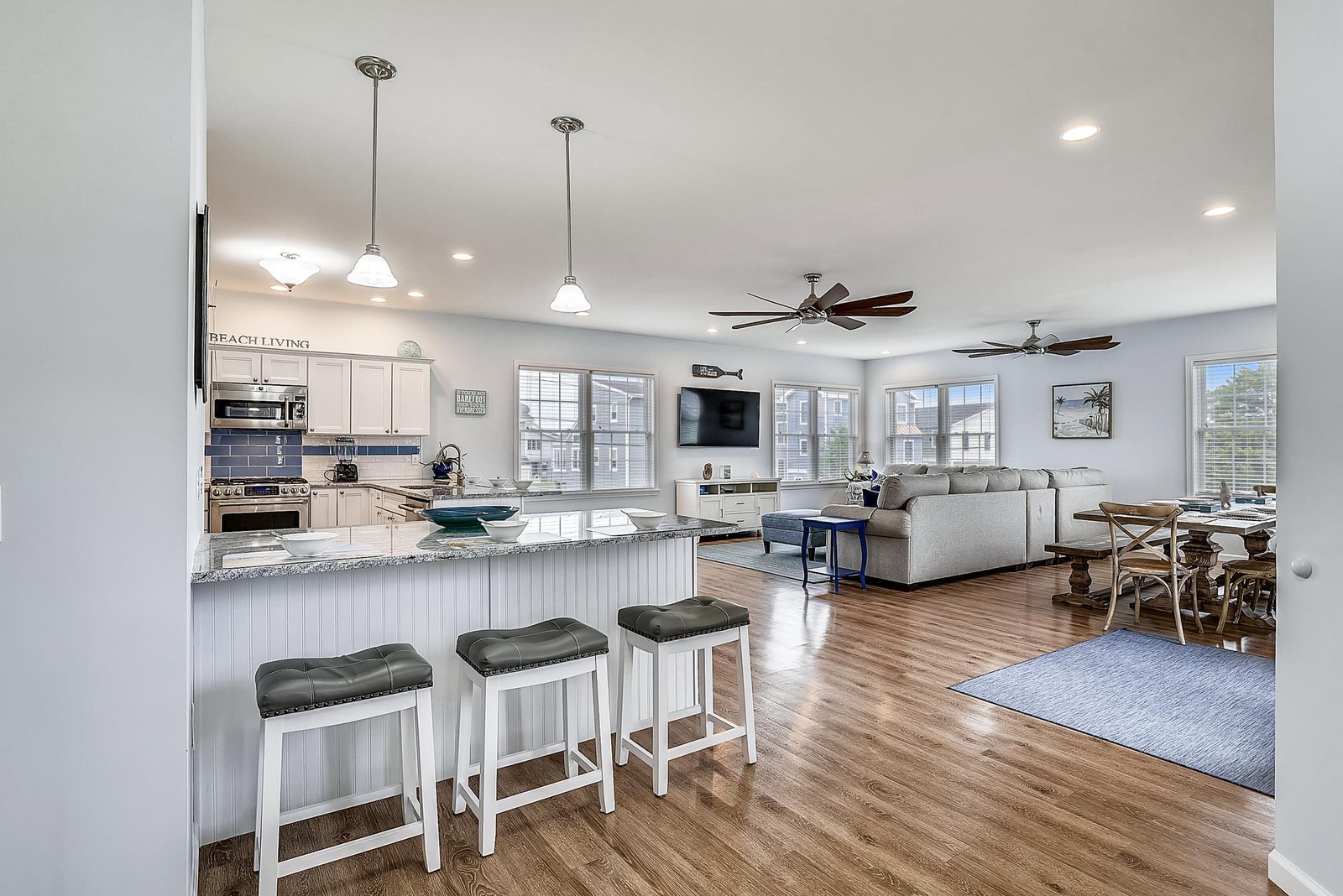 Bright open-concept space perfect for your beach vacation. Gather at the kitchen island, relax on the plush sofa, and dine together—all flooded with natural light.