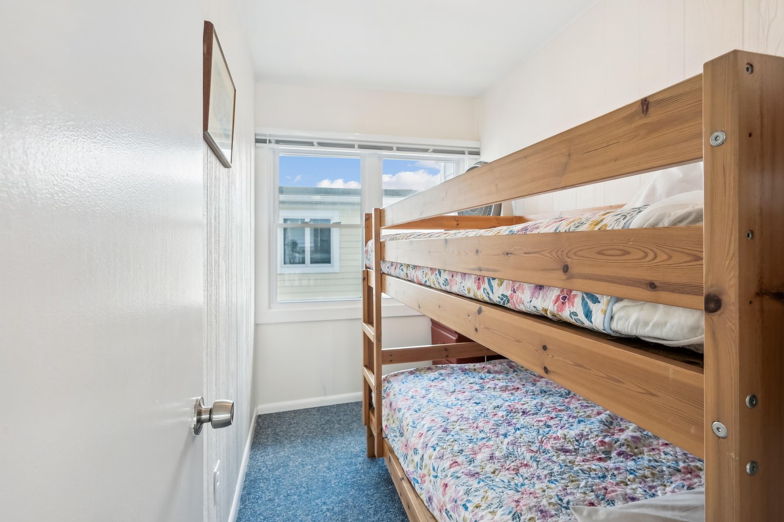 This cozy bunk room is perfect for kids or groups traveling together, with twin beds ready for restful nights and a bright window letting in natural light.
