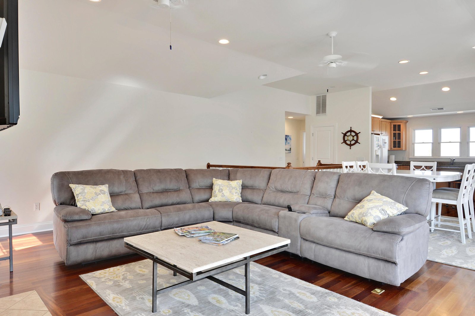 Sink into the plush sectional and let your beach getaway begin—warm hardwood floors, nautical touches, and an open, airy layout give you all the space to unwind in style.