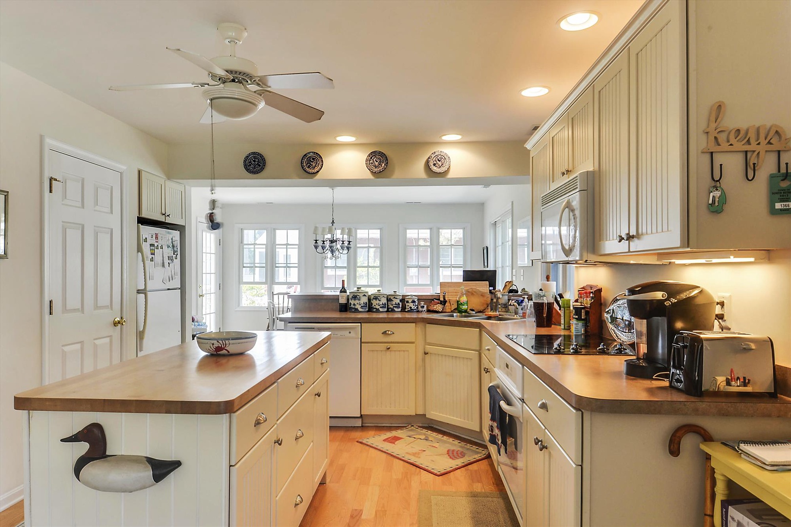 Your fully-equipped kitchen awaits, featuring warm wood countertops, ample storage, and a welcoming island where you can gather to cook, share meals, and create memories together.