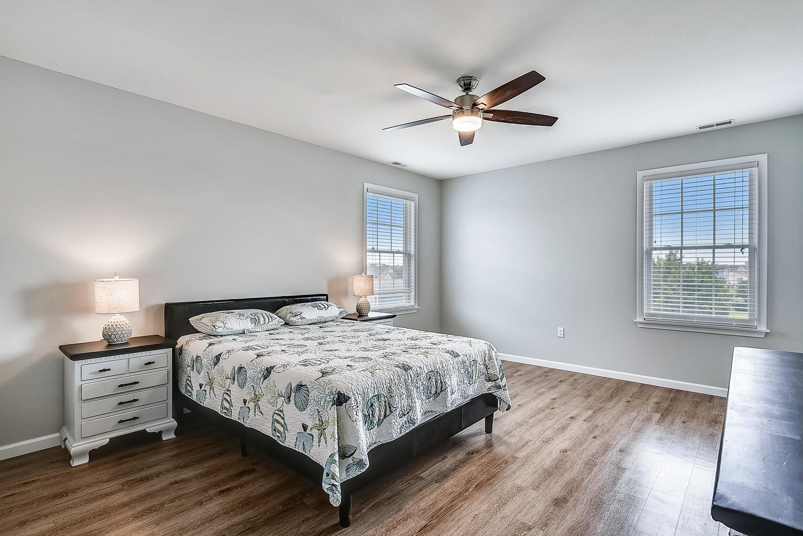 Settle into your peaceful bedroom with cool hardwood flooring and natural light—your ceiling fan keeps you comfortable while you rest and recharge.