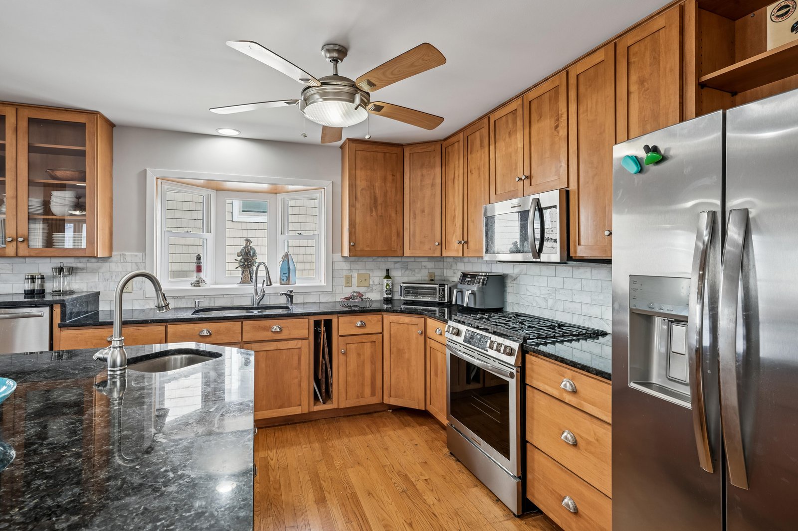 Your fully equipped kitchen features sleek granite countertops, stainless steel appliances, and warm wood cabinetry, creating the perfect space to whip up your favorite meals during your stay.
