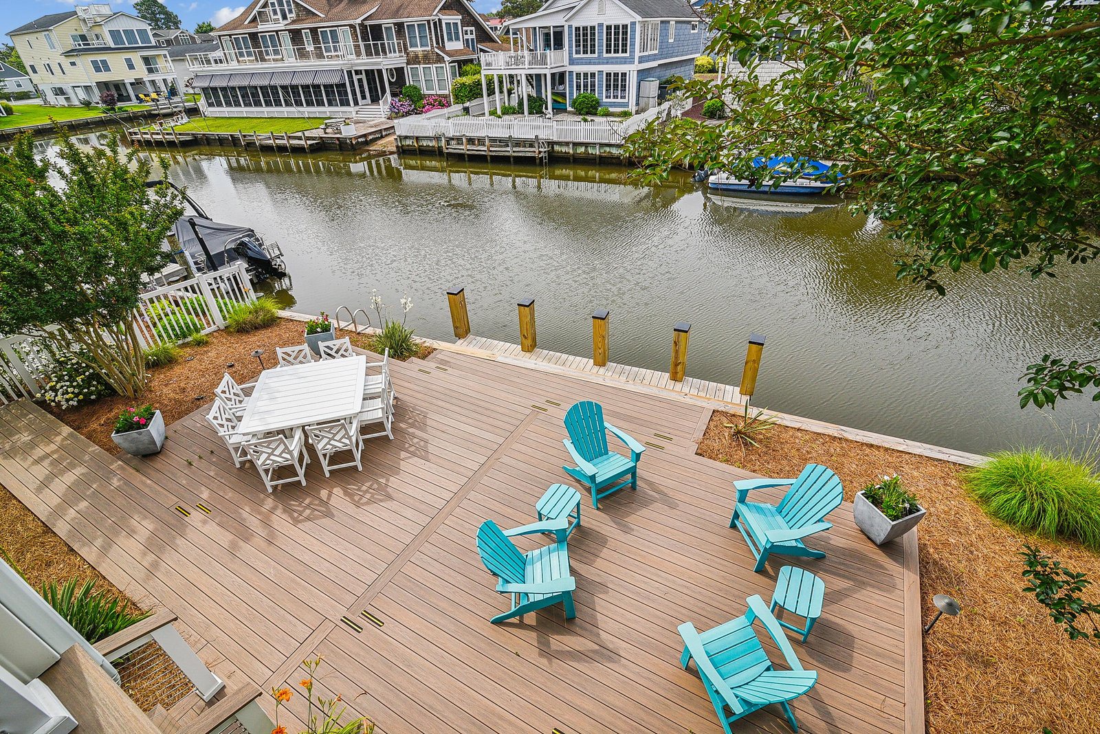 Waterfront homes frame the calm canal where your private dock and spacious deck await—a perfect spot for morning coffee or afternoon gatherings by the water.