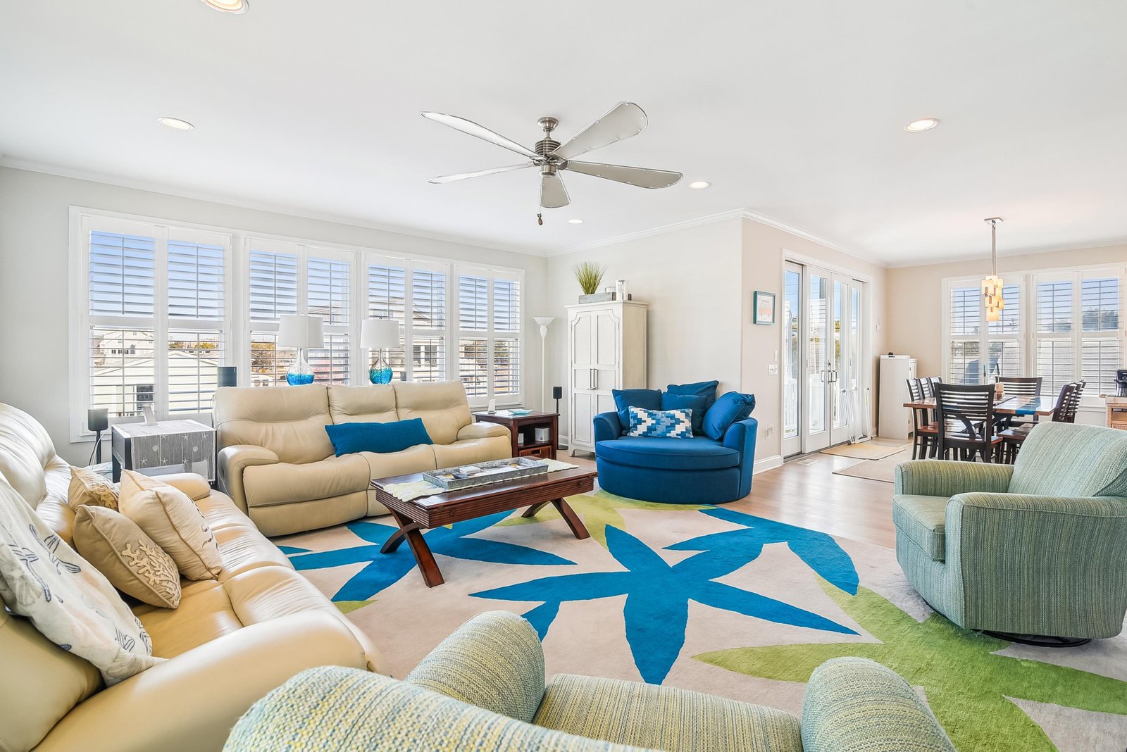 Settle into your bright, open living space where coastal charm meets everyday comfort. The breezy ceiling fan and playful blue accents bring a relaxed beach vibe.