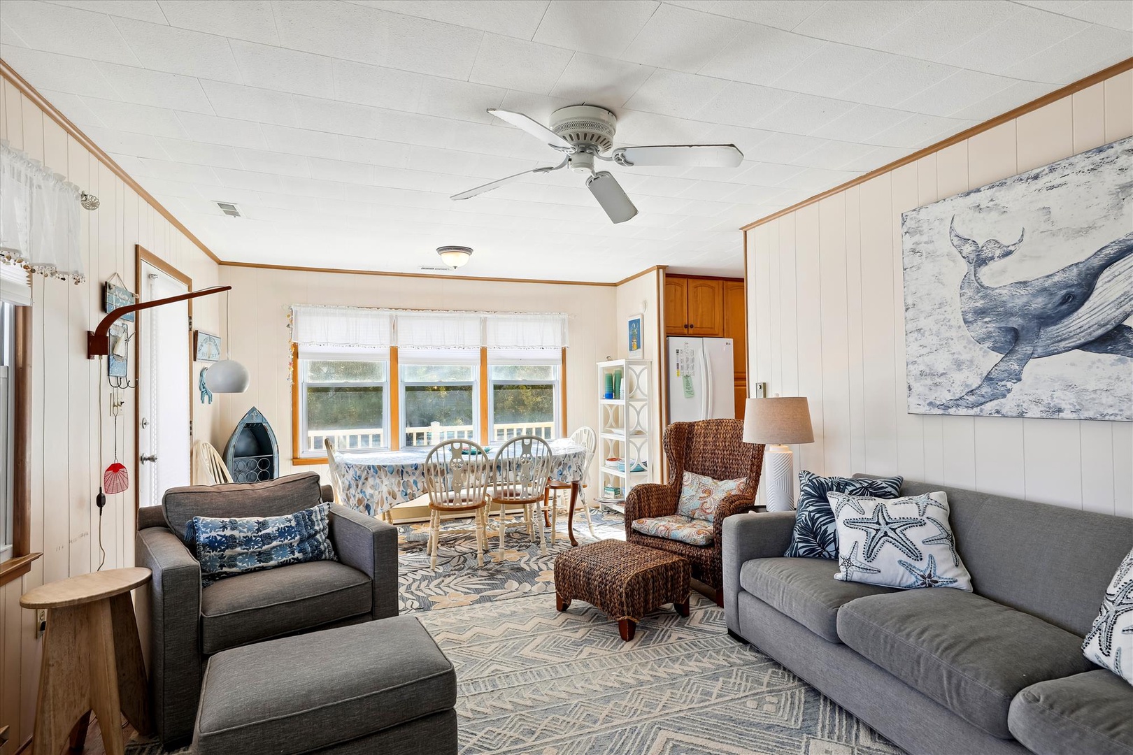 Sink into cozy coastal charm with plush seating and breezy nautical accents perfect for your downtime. Natural light pours through picture windows while the ceiling fan keeps you comfortable all day long.