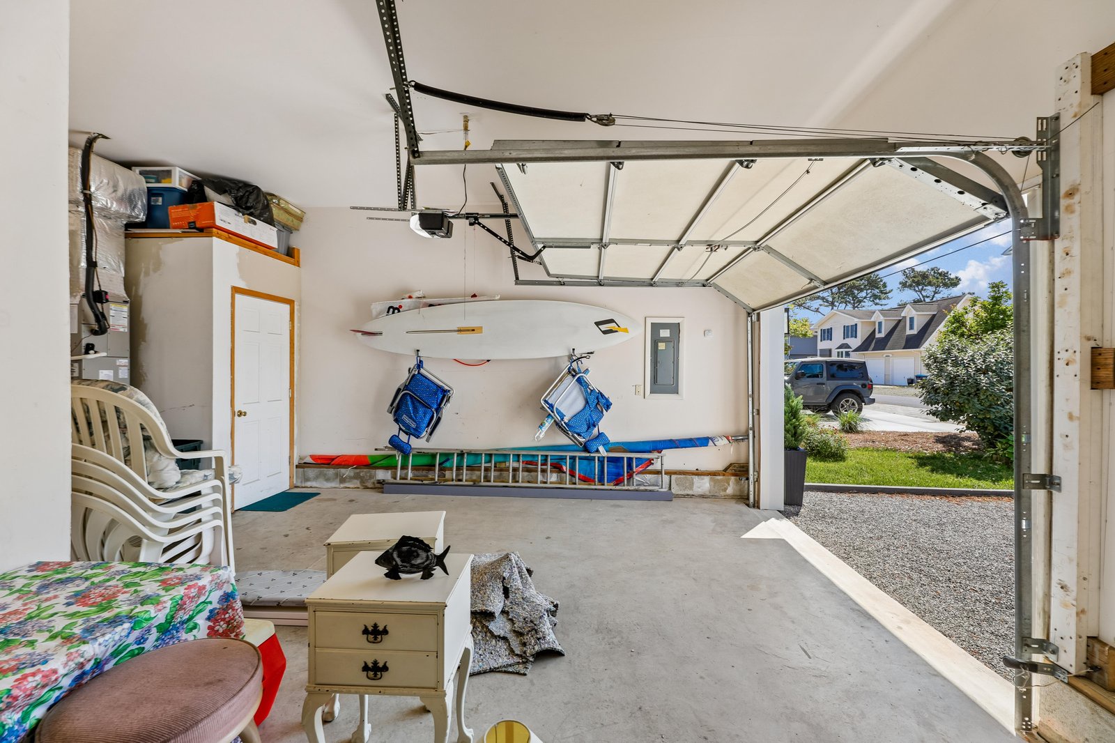 A clean, organized garage with convenient storage solutions, beach gear, and direct access to the property—perfect for your coastal getaway essentials.