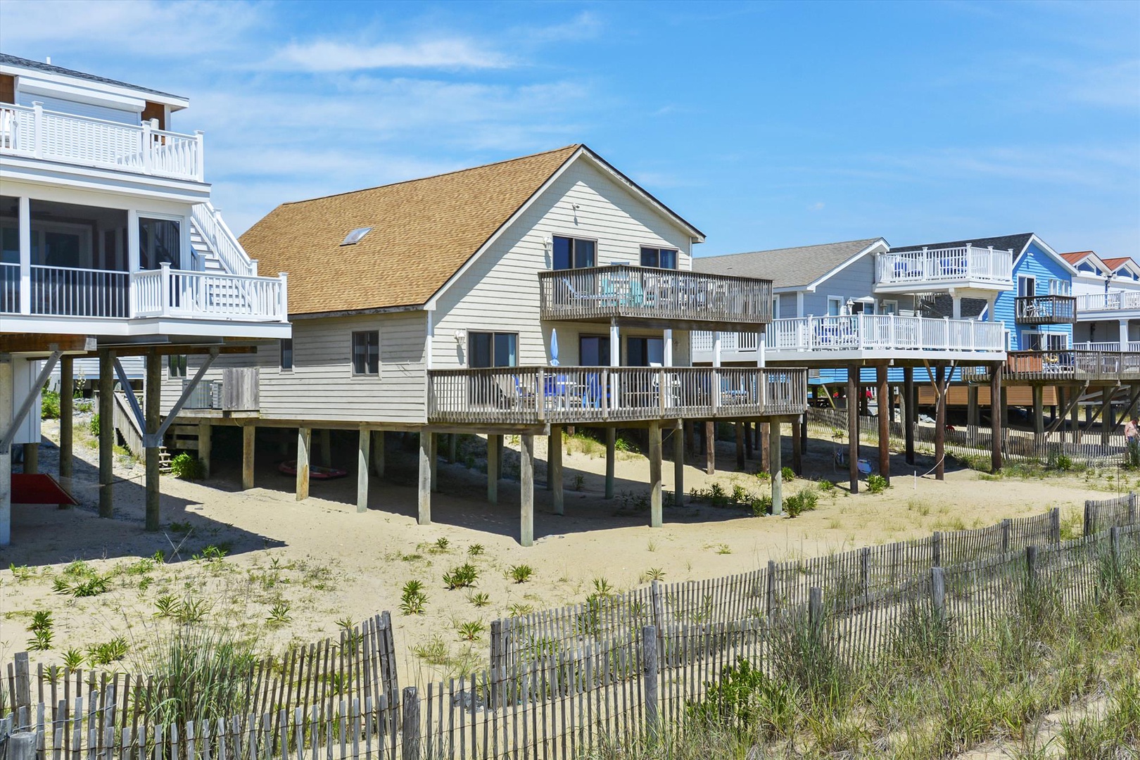 Beachfront properties on stilts offer direct access to sandy shores and coastal surroundings in a quiet neighborhood setting.