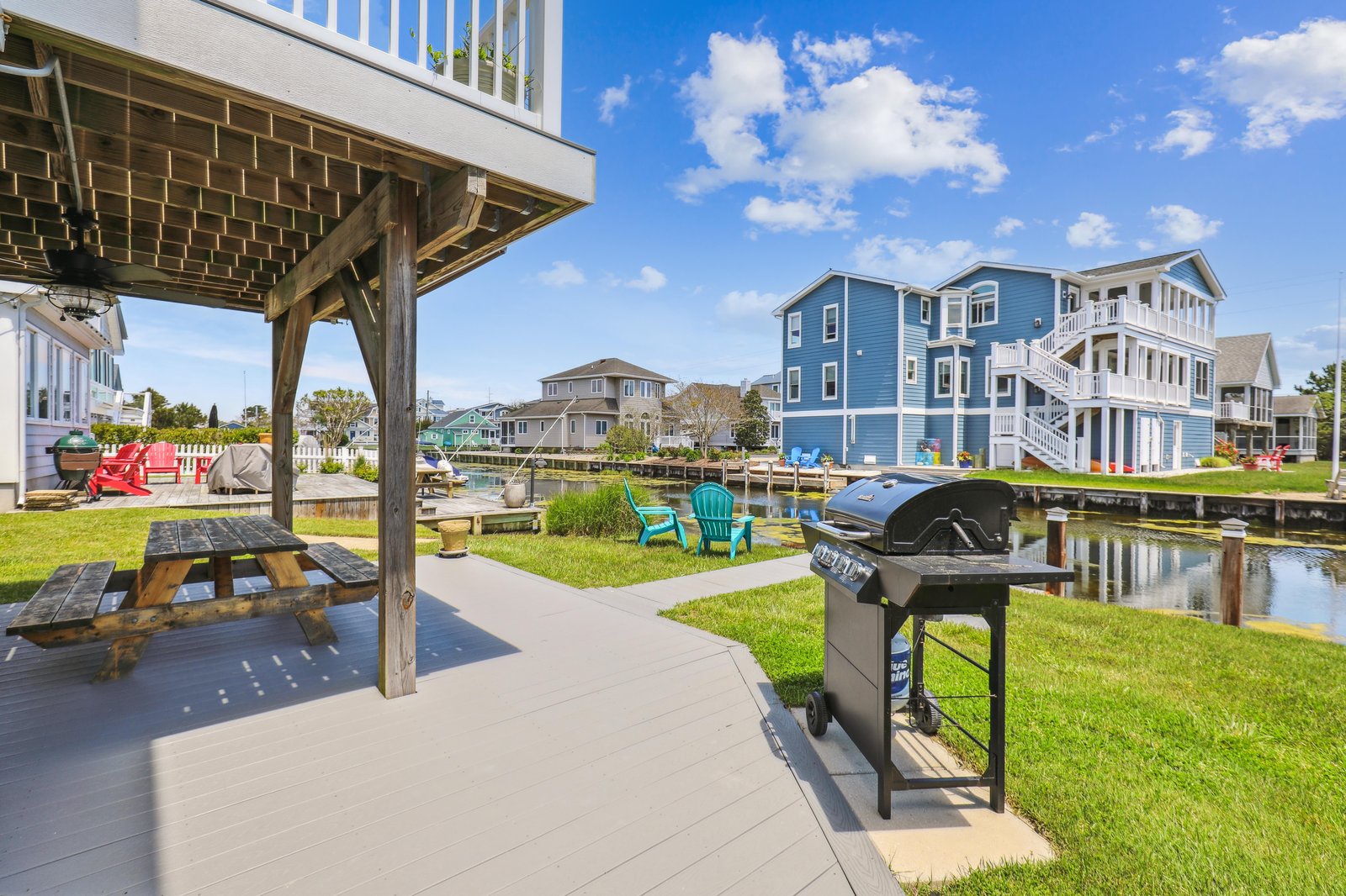 Grill your favorite meals outdoors under a shaded pergola, steps from calm canal waters and a peaceful neighborhood setting—perfect for relaxing afternoons.