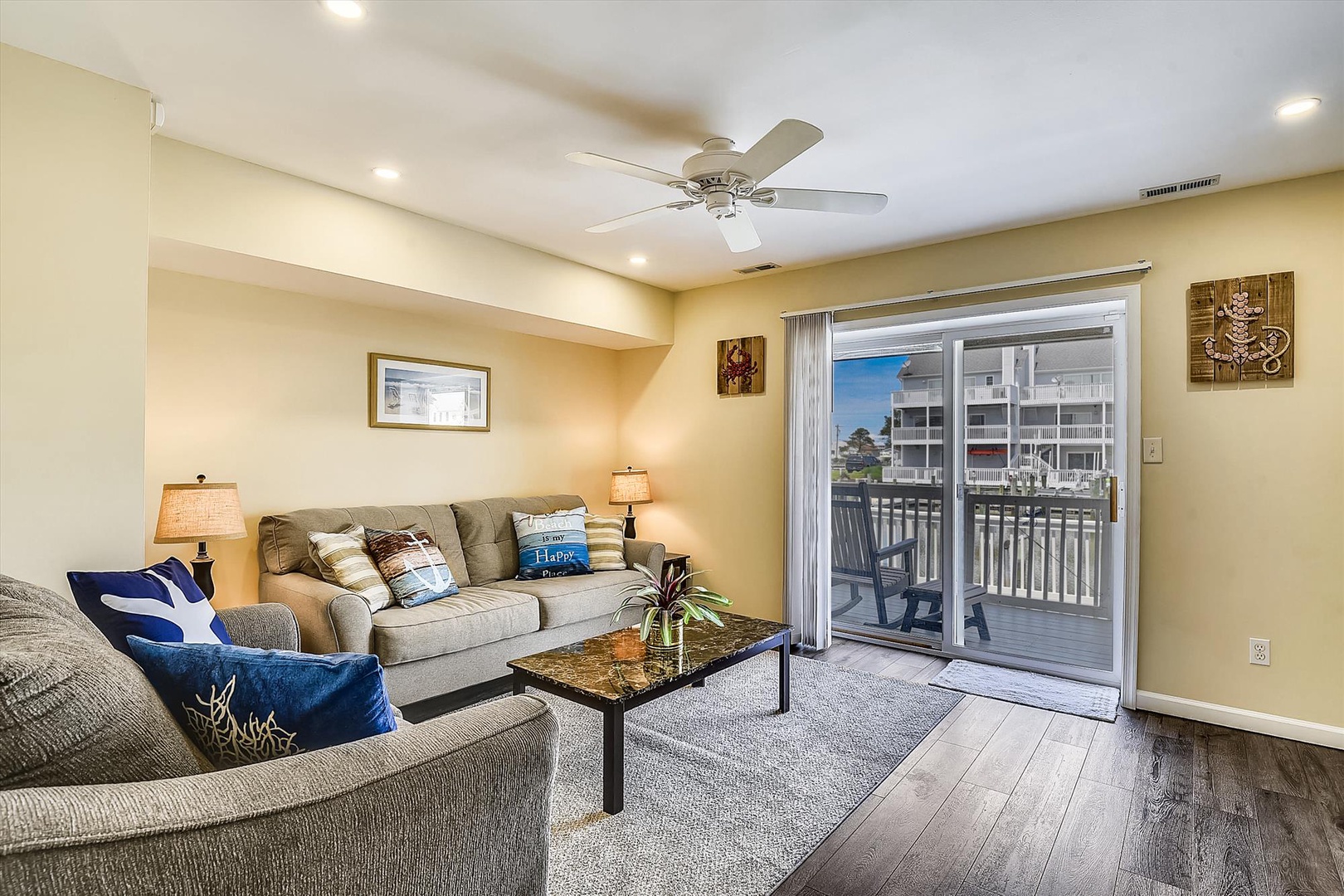 You'll love unwinding in this bright living space with a ceiling fan, cozy seating, and a private balcony where you can enjoy your morning coffee or evening relaxation.