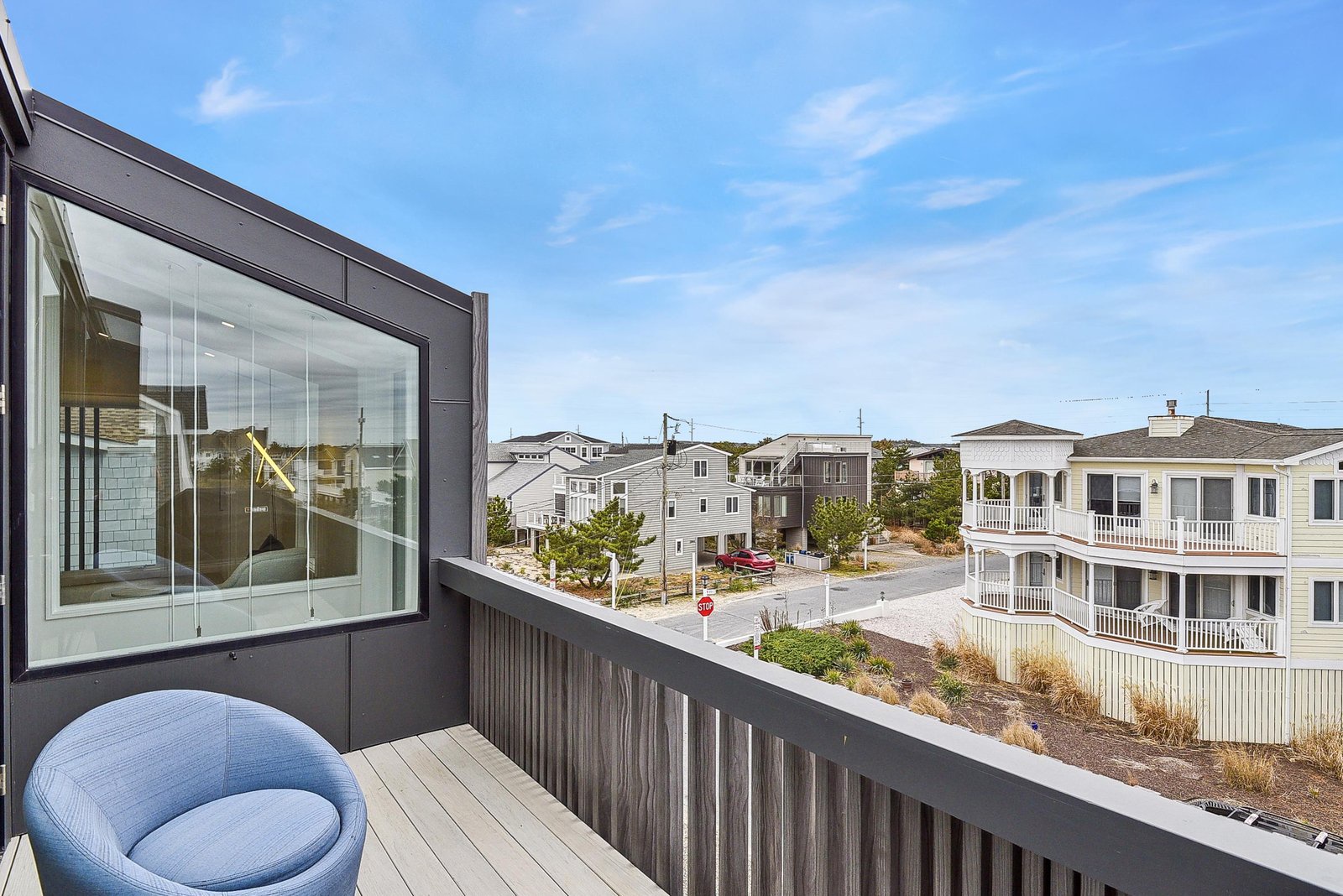 Step onto your private balcony to savor morning coffee as the coastal breeze drifts by. The outdoor space perfectly frames quiet neighborhood charm and nearby beach access.