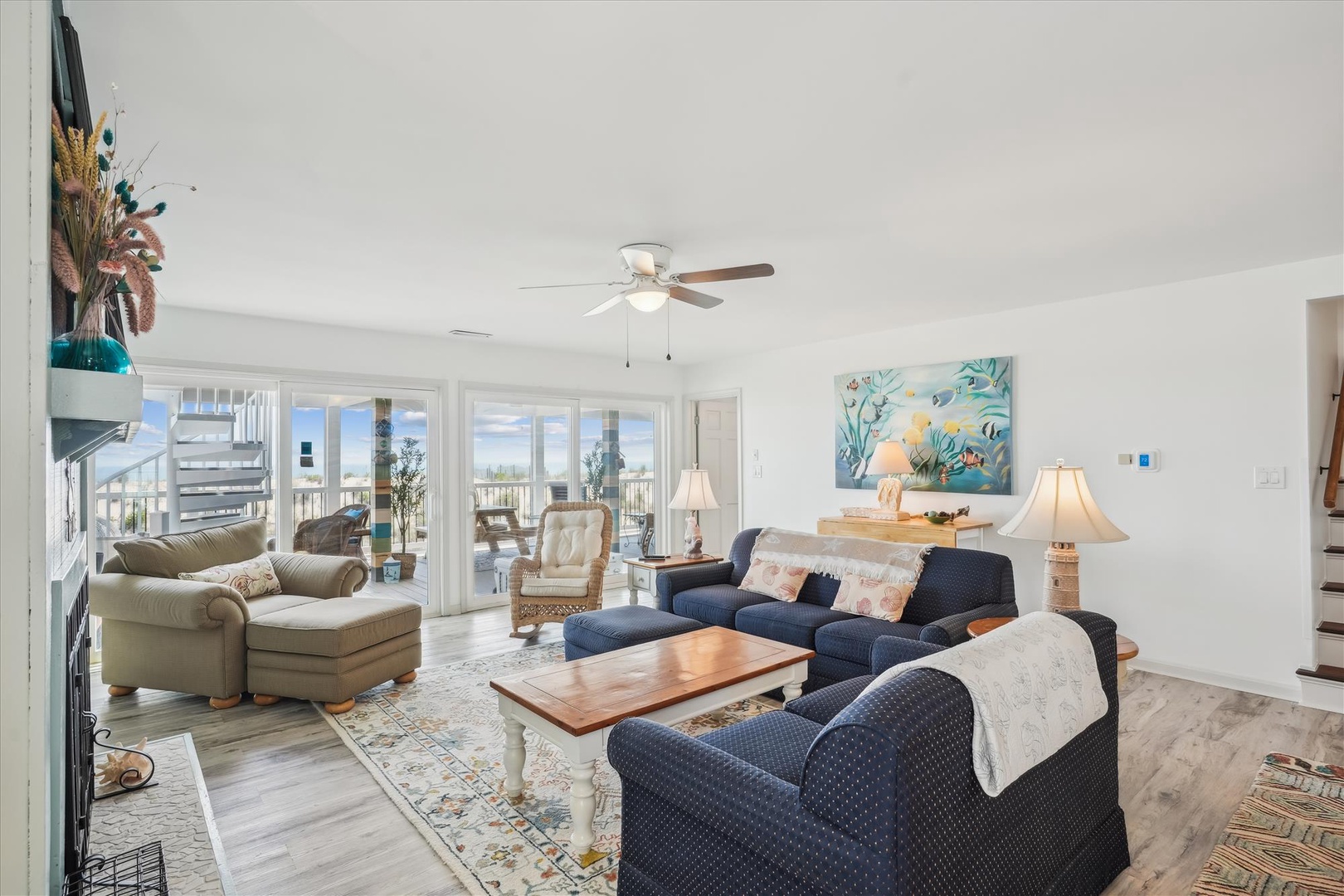 Unwind in your bright, open living room with cozy coastal charm. Sink into plush seating, enjoy ocean-inspired décor, and feel the gentle breeze from your balcony doors.