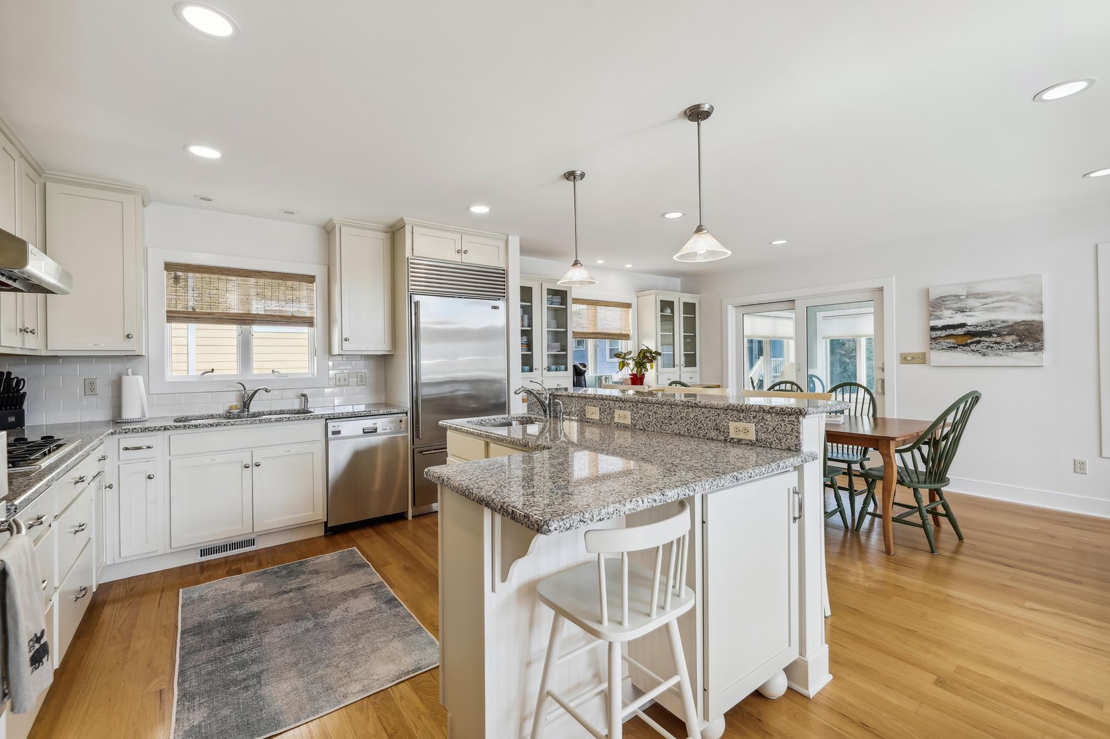 Step into your open, airy kitchen where morning coffee flows as easily as conversation. Bright cabinetry, granite counters, and an island make meal prep a breeze, while the adjoining dining nook sets the stage for laughter-filled gatherings.