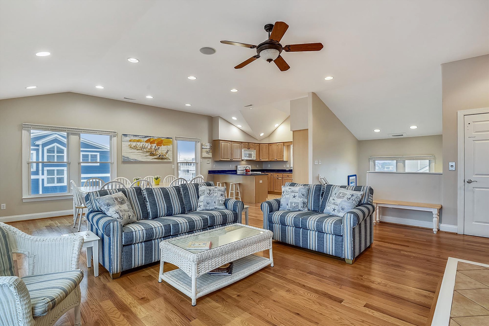 Unwind in this sun-drenched living space with cozy nautical seating, vaulted ceilings, and open views to the kitchen—your perfect home base for coastal relaxation.