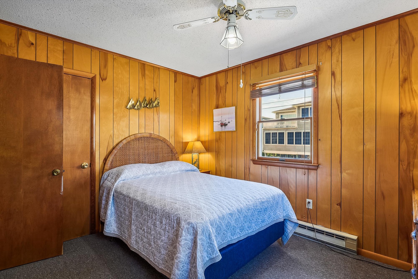 Your cozy bedroom features warm wood-paneled walls and a plush bed that invites restful sleep after a day of exploring the area.