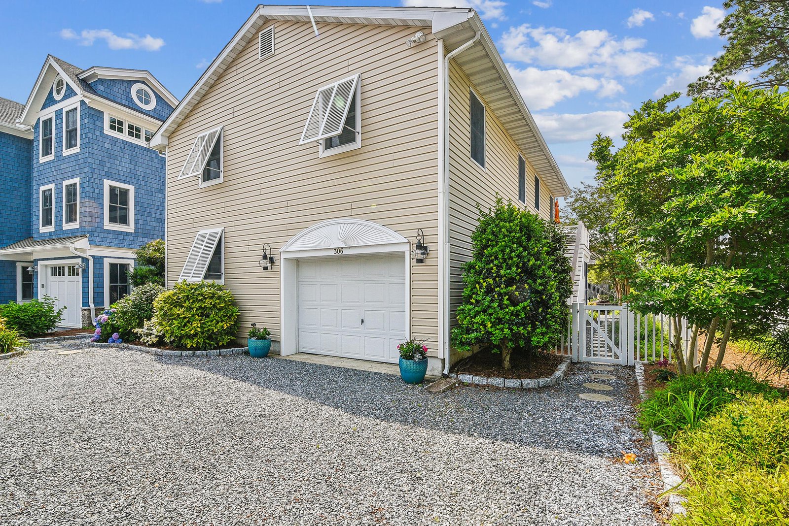 The exterior features a welcoming entrance with convenient parking and charming coastal landscaping, nestled in a quiet neighborhood near the shore.