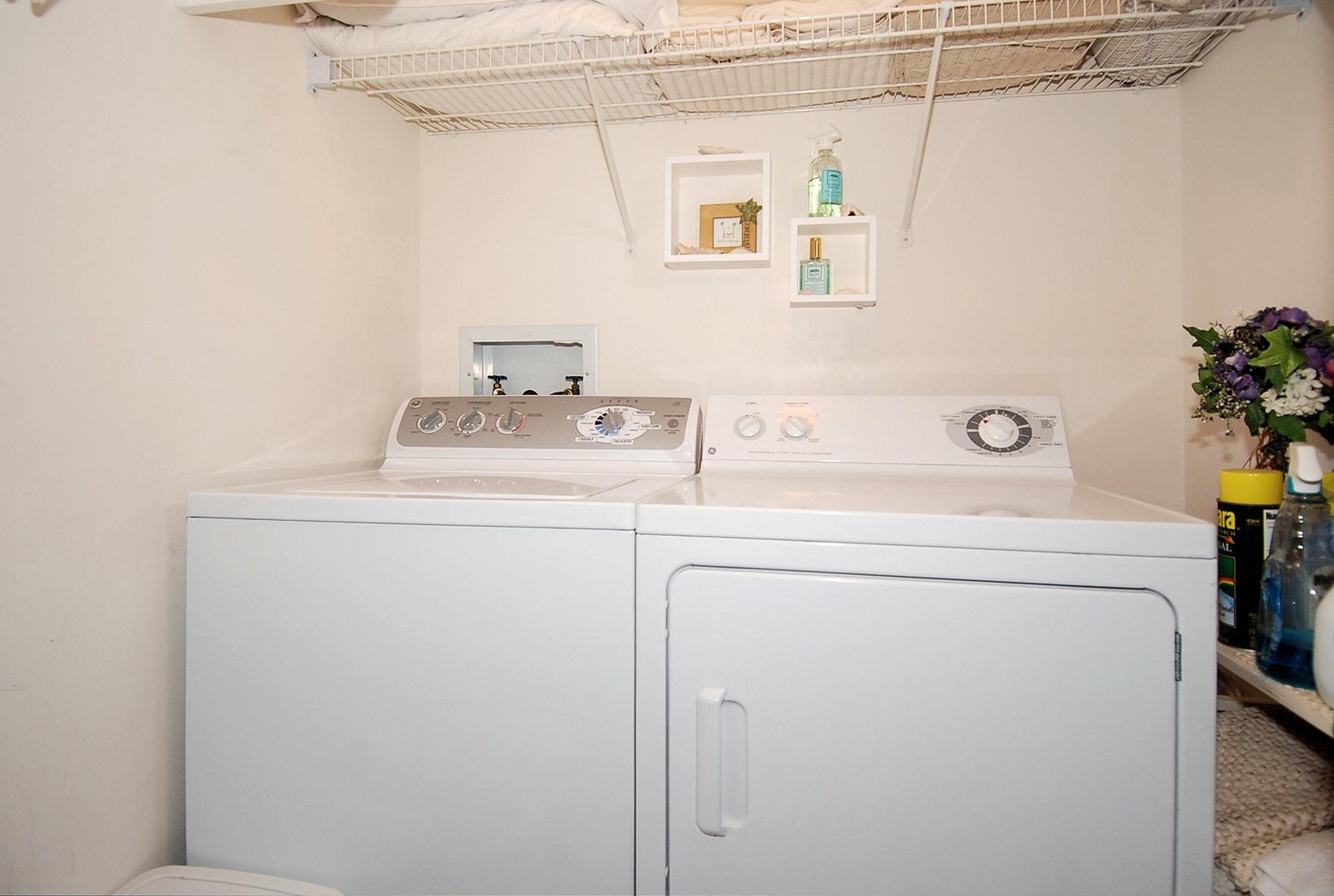 Your laundry is covered with a full-size washer and dryer tucked away in a convenient, bright space with storage above.