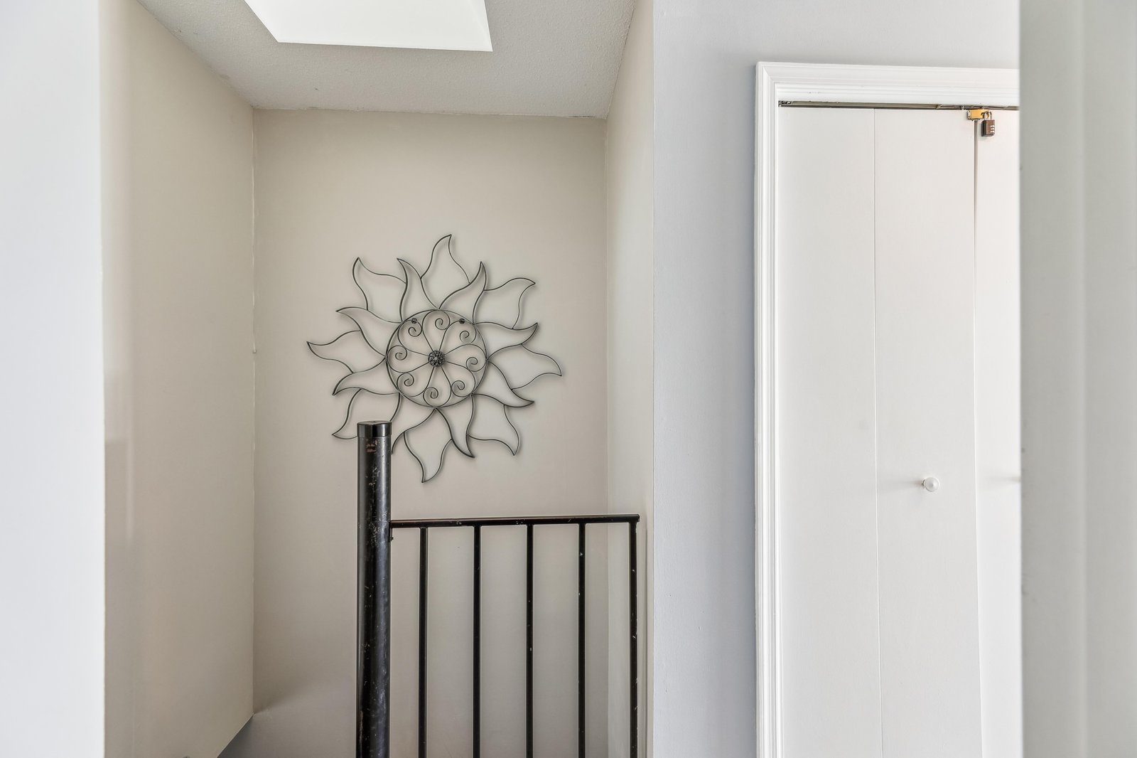 Natural light floods this space through the skylight, brightening your path and creating a welcoming sense of openness as you move through the home.