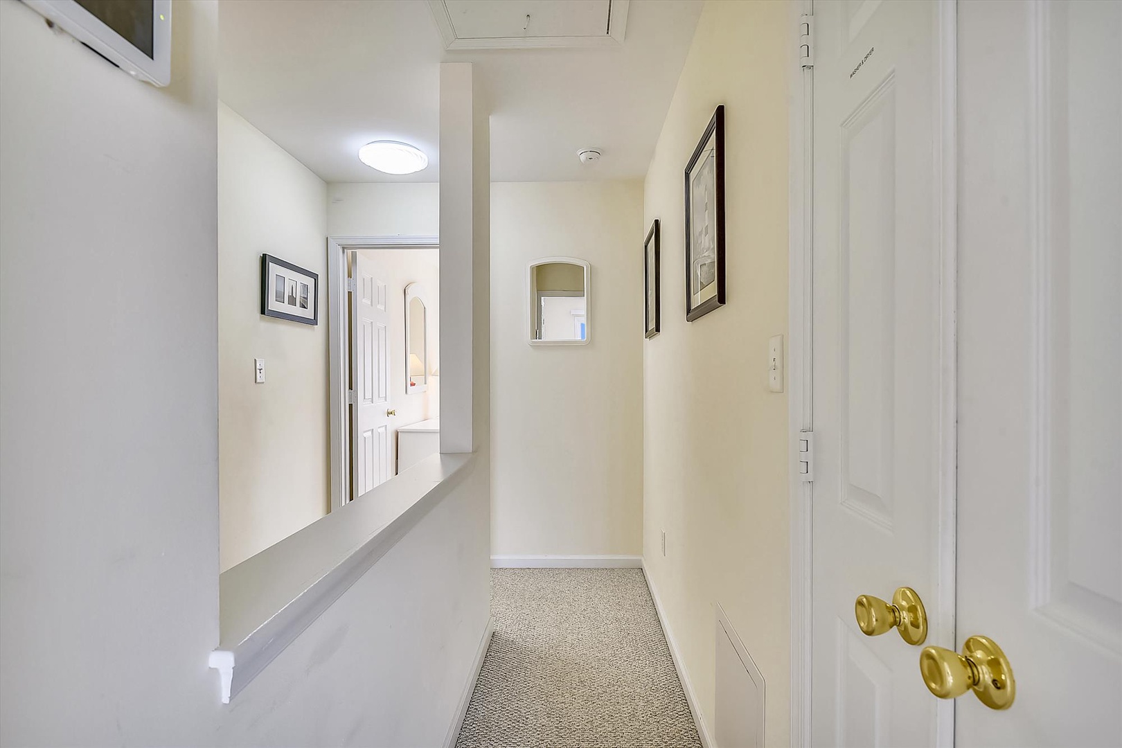 A bright, welcoming hallway with clean lines and thoughtful touches like framed artwork guides you from room to room with ease and comfort.