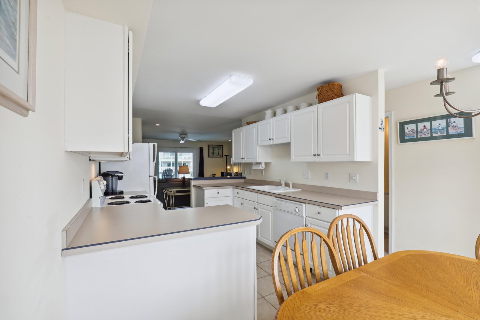 Your kitchen has everything you need—bright white cabinets, plenty of counter space, and a welcoming dining table where you can share meals and plan your adventures.