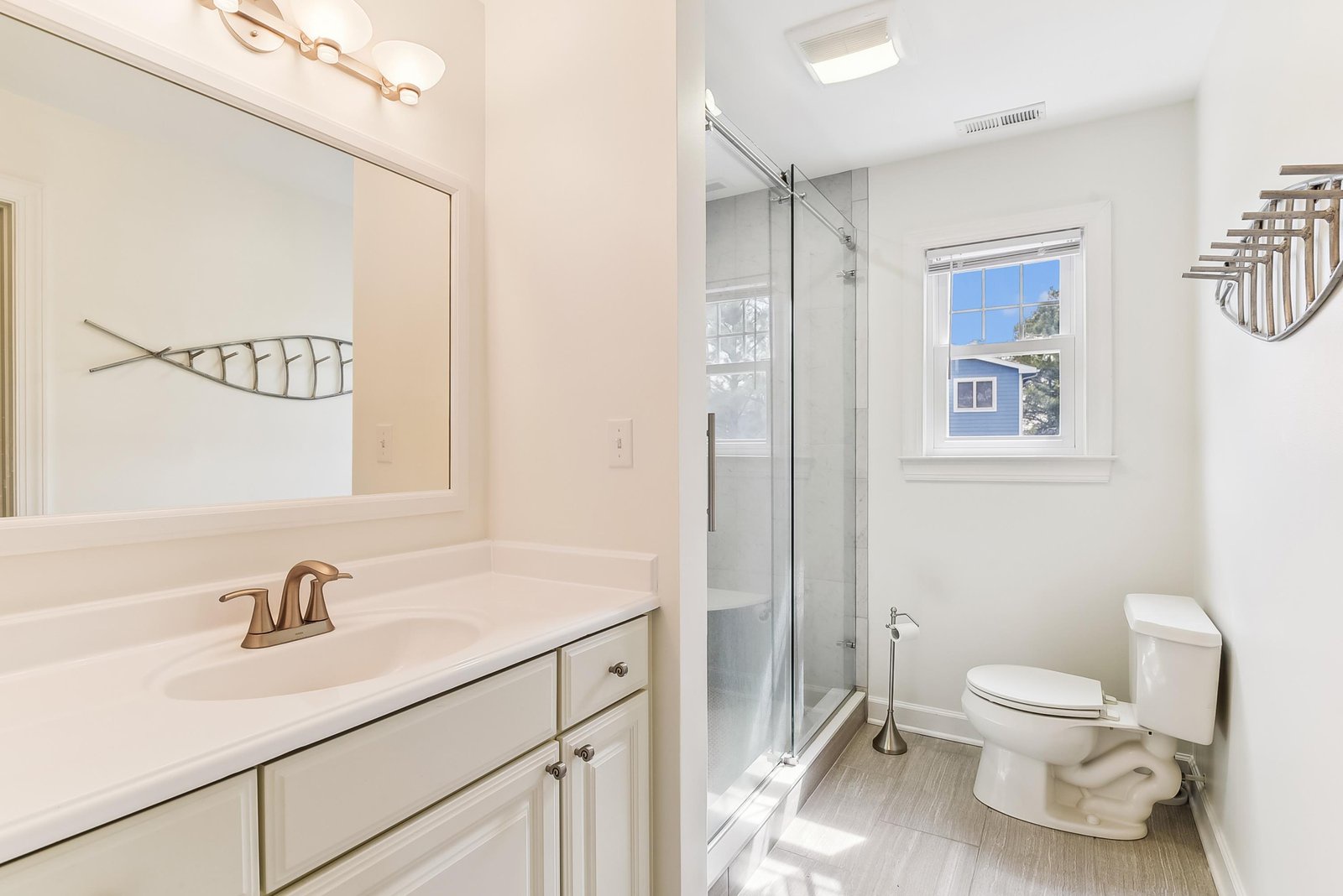 Step into your modern bathroom, where natural light pours through the window and gleaming fixtures invite you to refresh and unwind.