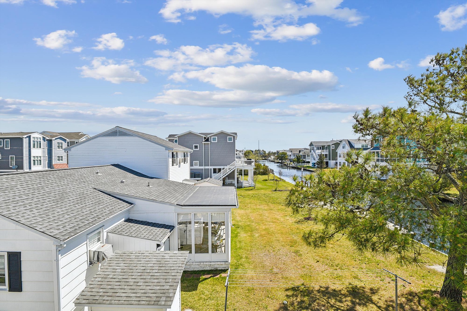 Aerial view showcasing the property's prime waterside location in a peaceful coastal neighborhood with canal access and scenic surroundings.