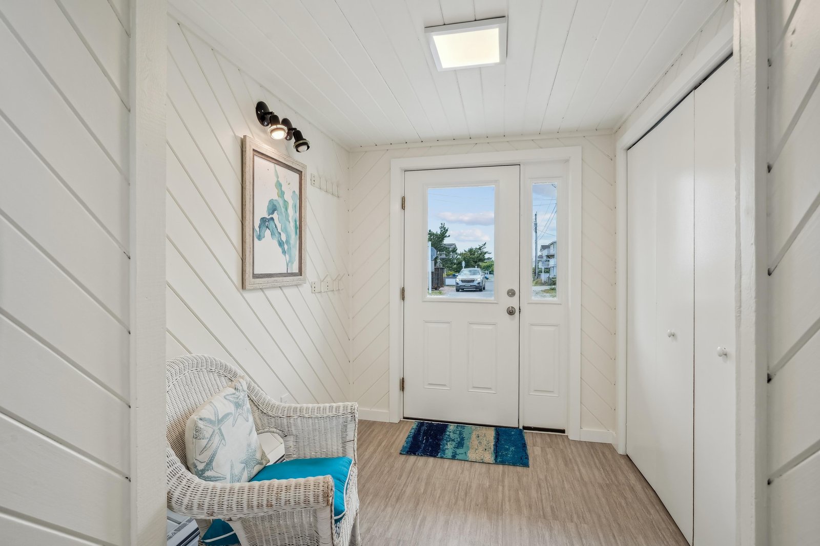 Charming white shiplap walls and coastal-inspired decor welcome you to your home away from home. Step through the bright entrance and feel the easy beach vibes start immediately.