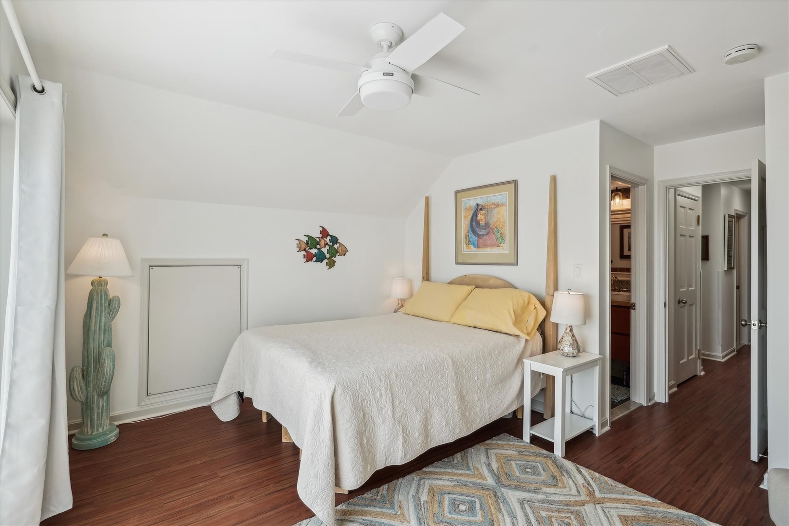 Sink into comfort in this serene bedroom where soft linens and coastal charm invite your best night's sleep. A cozy retreat after exploring the area.