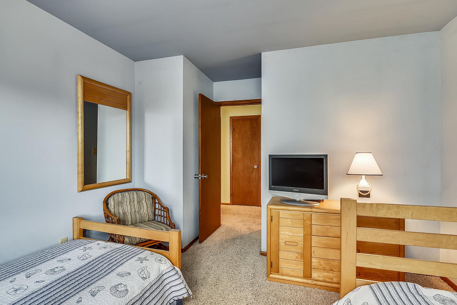 Your comfortable bedroom features two cozy beds and warm wood furnishings, creating a restful retreat after a day of adventure.
