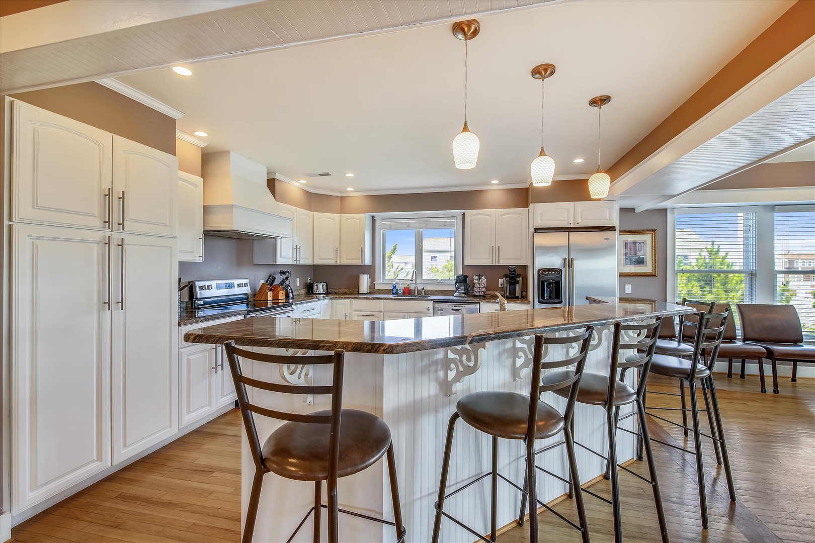 Your gourmet kitchen awaits with gleaming granite countertops, stainless steel appliances, and a spacious island perfect for gathering over morning coffee or evening meals together.