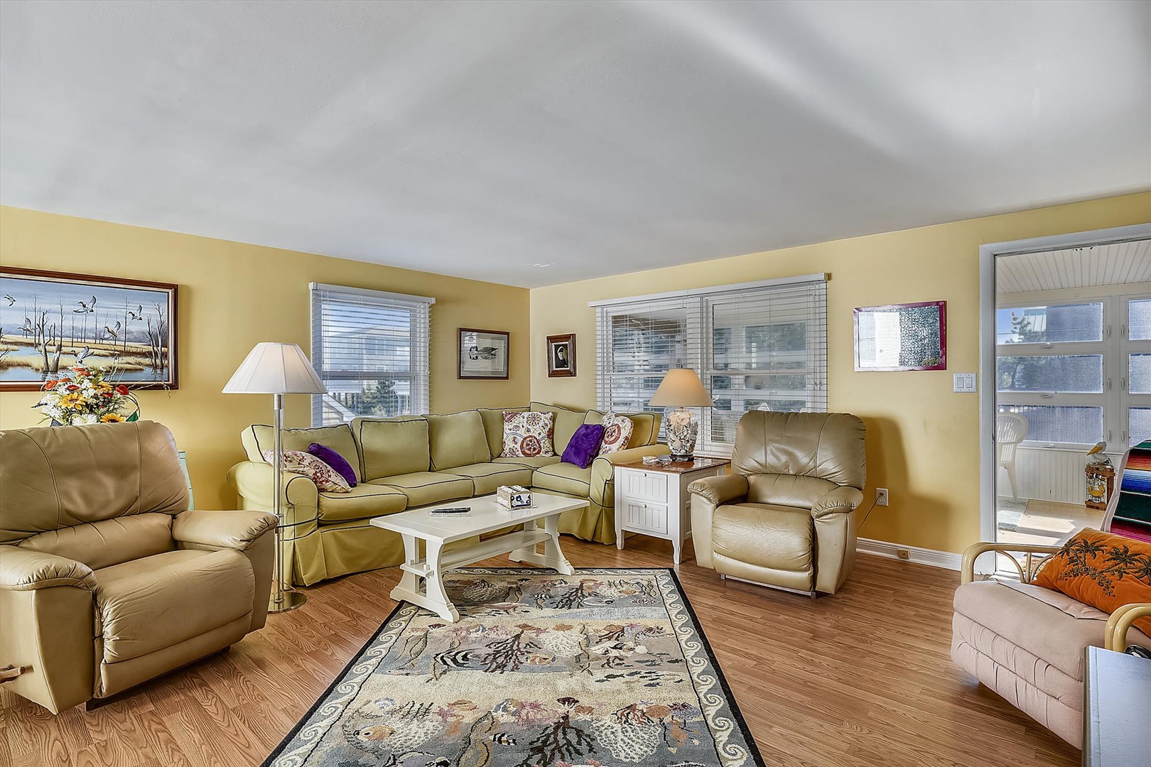 Sink into plush leather seating in your bright, spacious living room. Natural light pours through multiple windows, warming the hardwood floors and inviting you to unwind in total comfort.