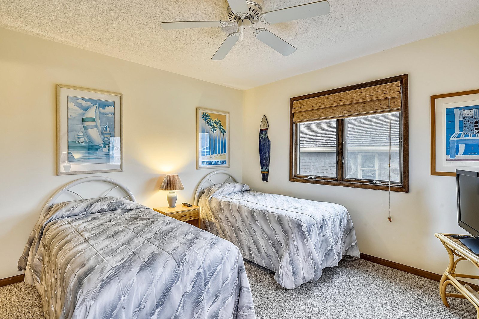 Drift off in comfort with two cozy twin beds and a soothing coastal vibe, while the ceiling fan keeps you cool all night.