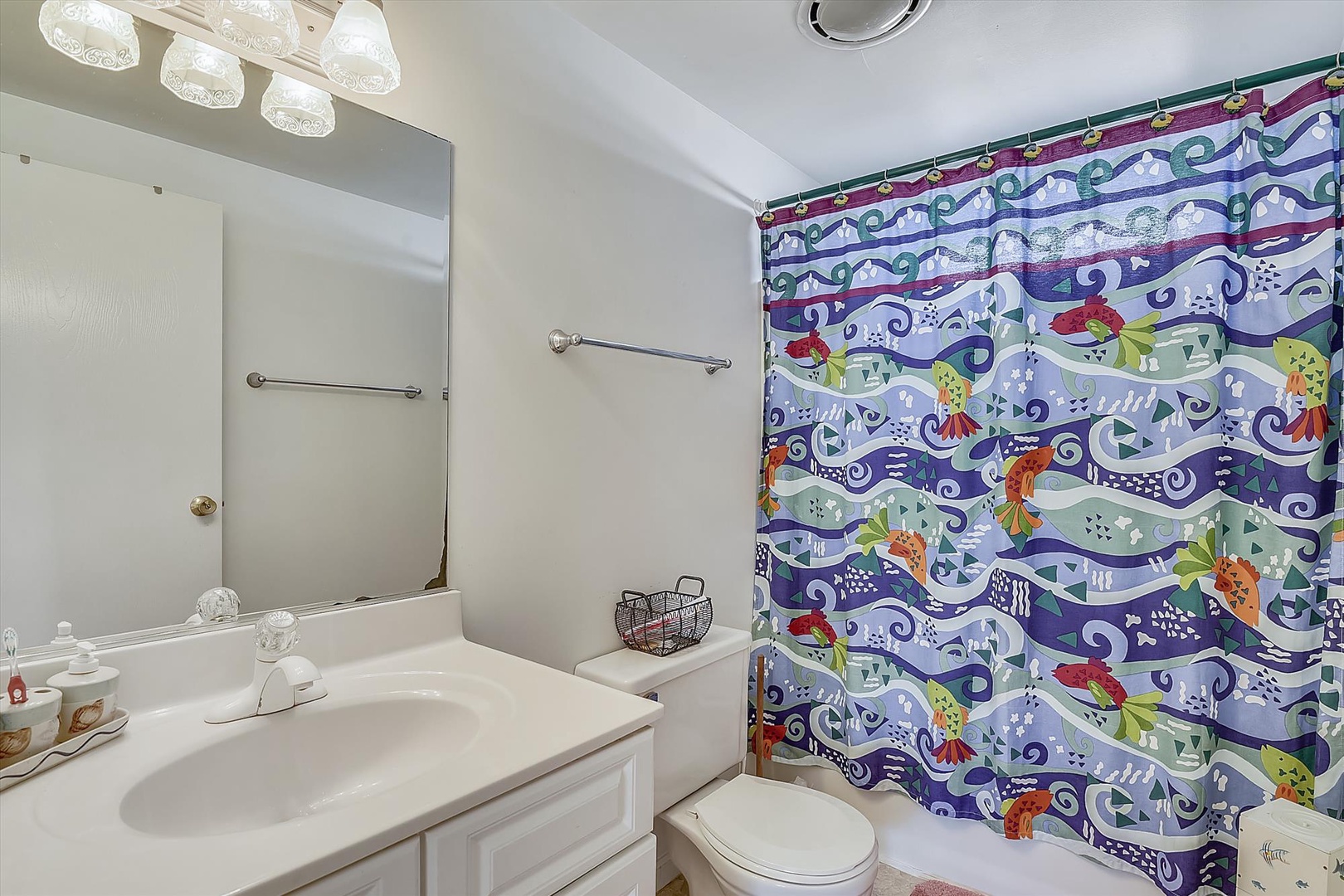 Freshen up in your bright, cheerful bathroom with a whimsical tropical fish shower curtain that brings playful ocean vibes to your morning routine.
