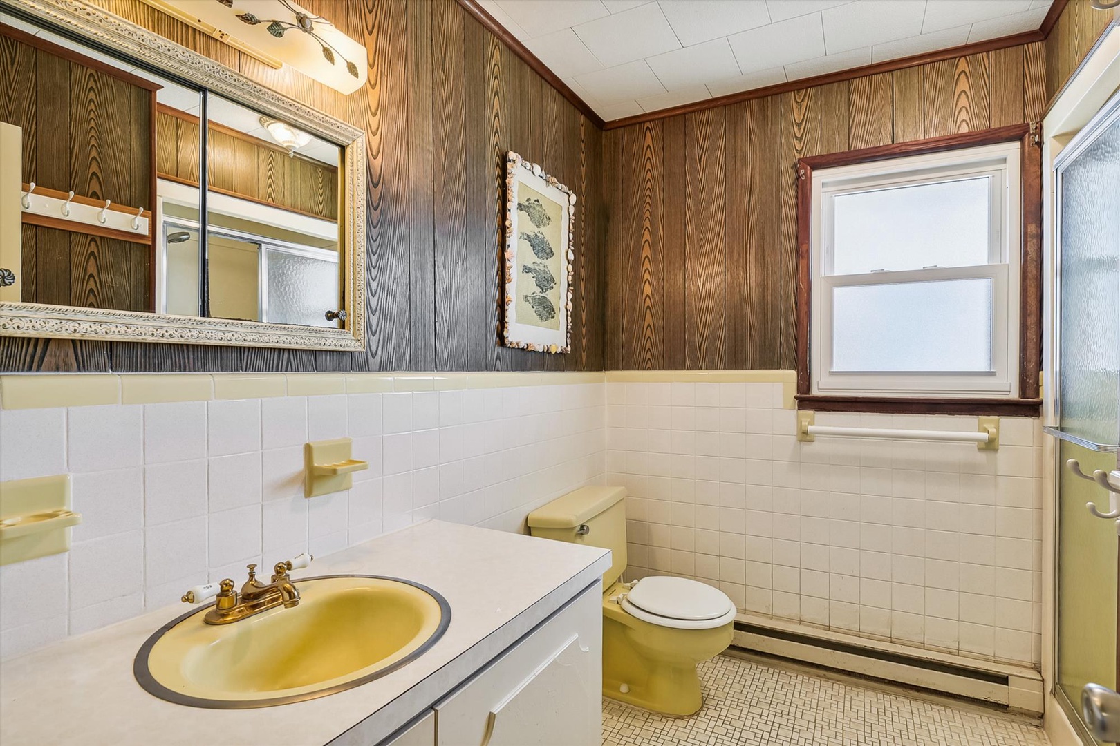 Step into a charming retro bathroom featuring vintage wood paneling, classic tile work, and original fixtures that give this space timeless character and authentic mid-century appeal.