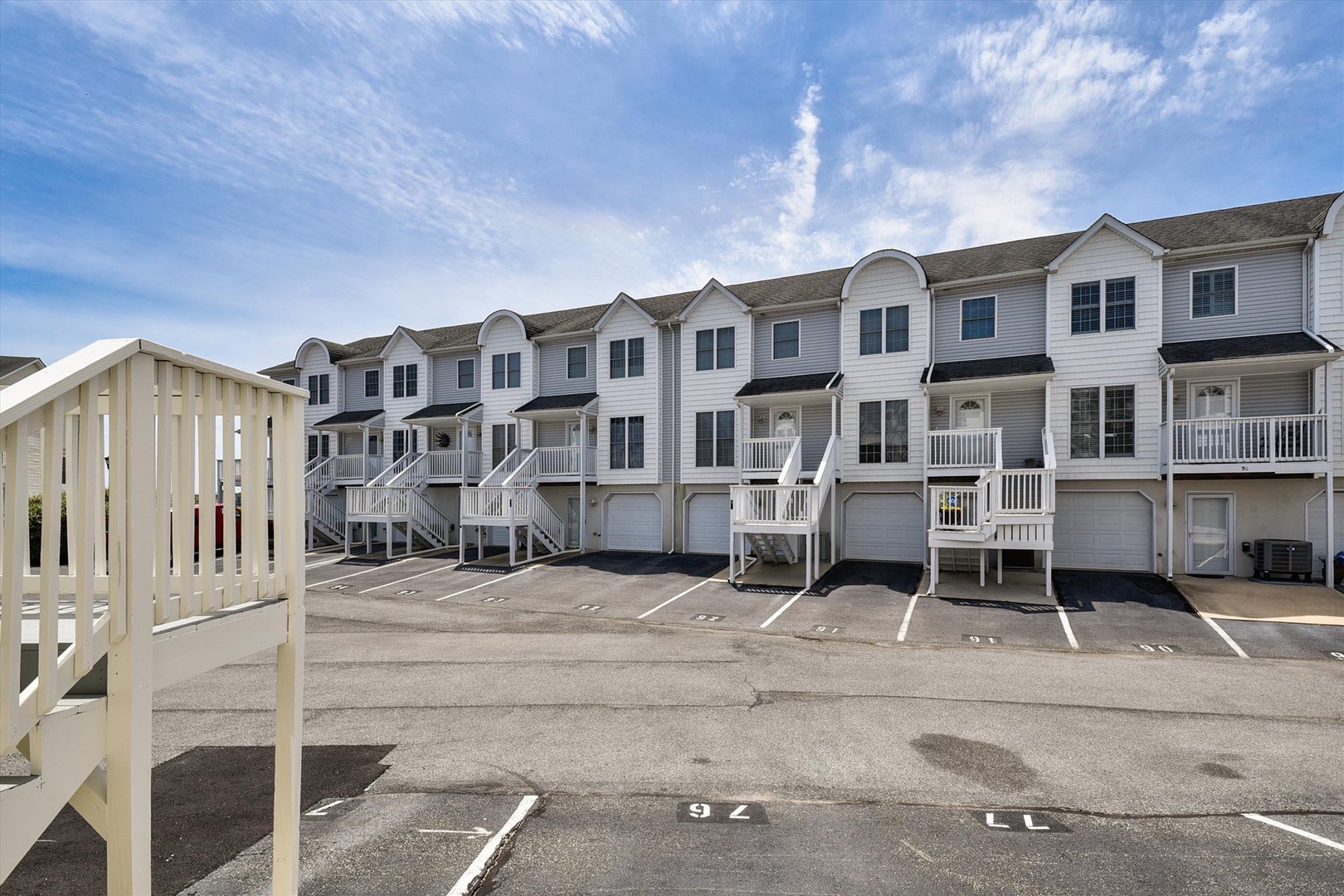 The property offers spacious townhome-style accommodations with private garage parking and convenient outdoor staircase access to each unit.