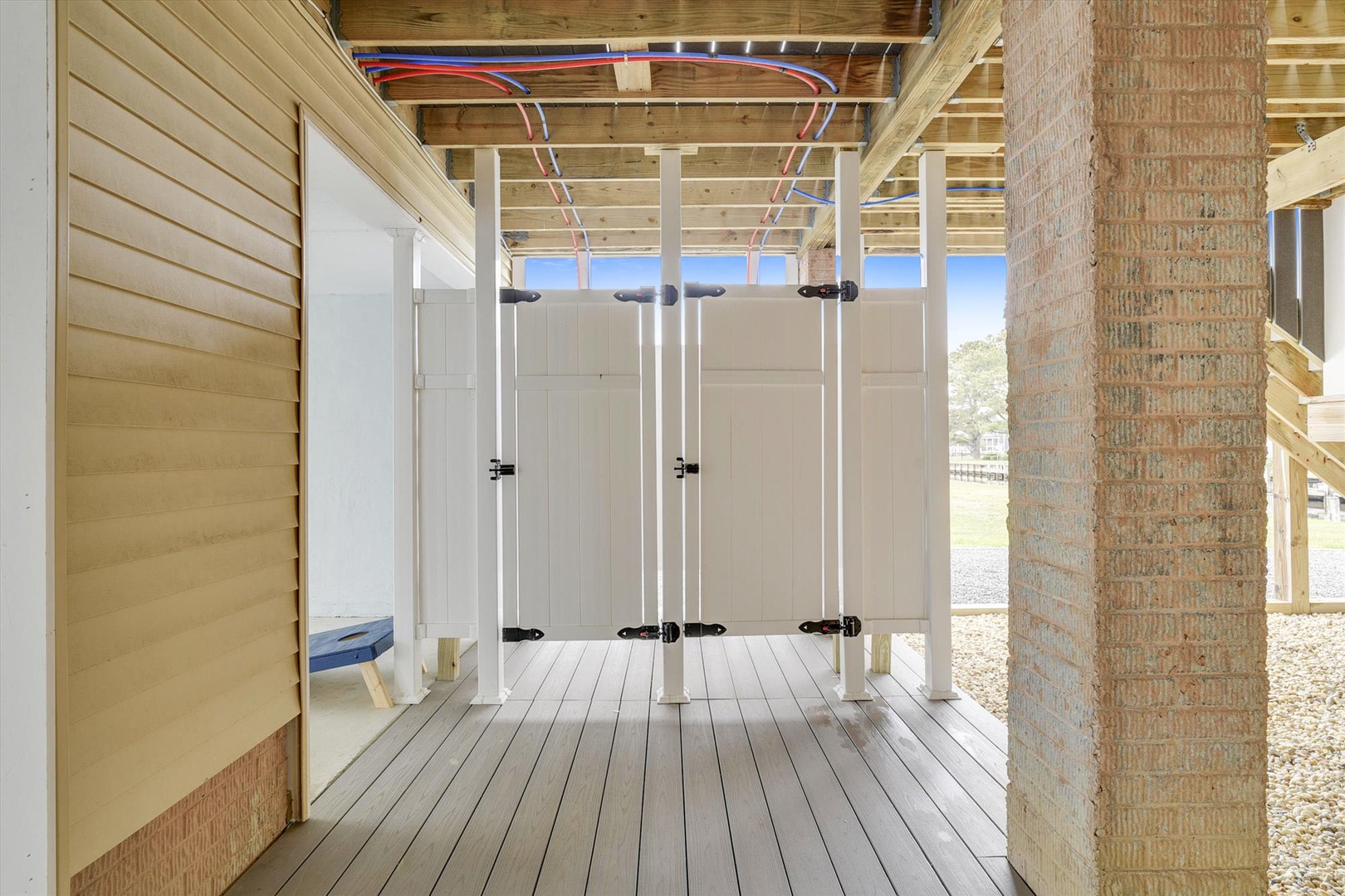 An outdoor shower area provides a convenient spot to rinse off after the beach, with private stalls and open-air design for a refreshing experience.