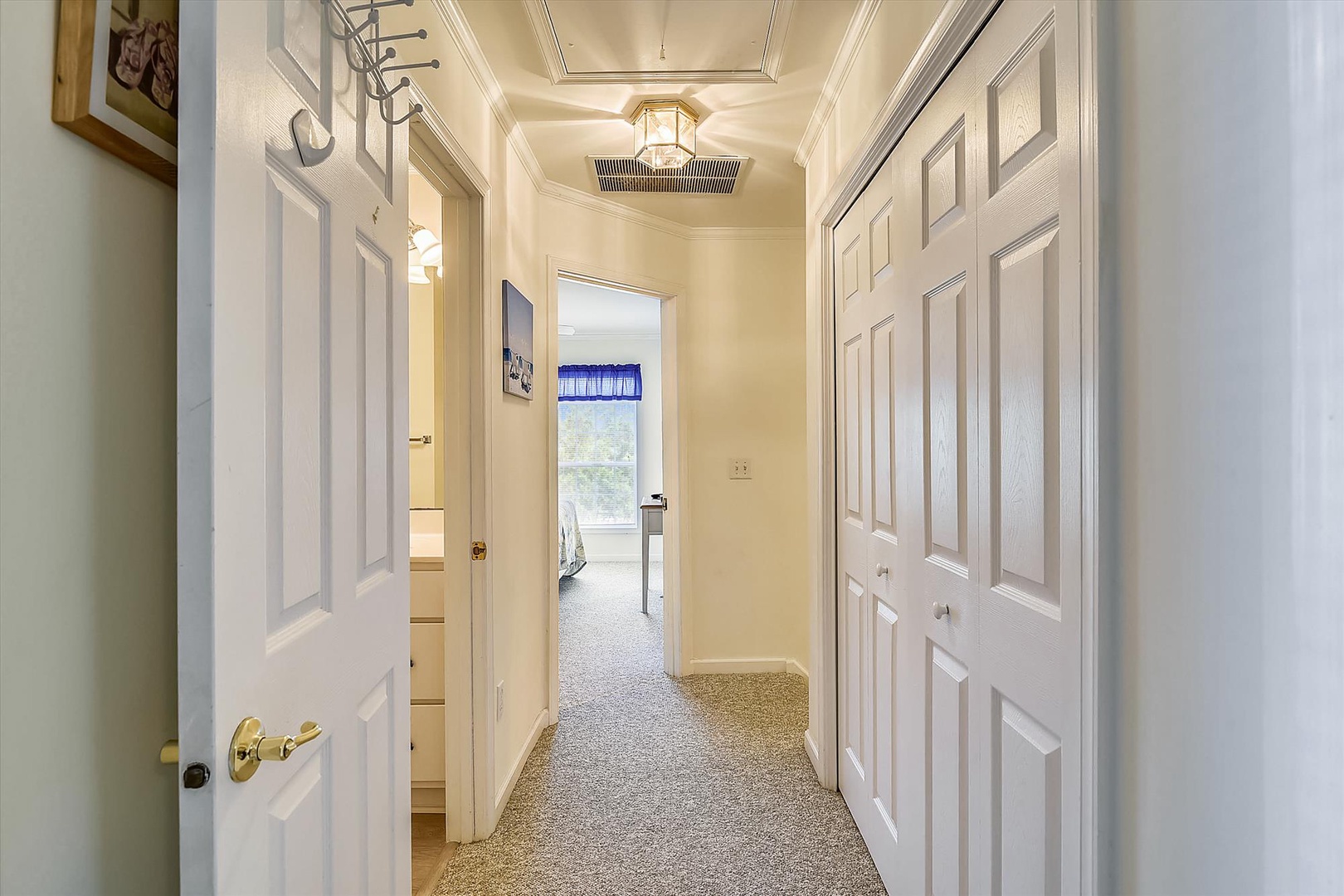 A bright hallway connects your private spaces, with warm lighting and thoughtful details guiding you through your comfortable retreat.
