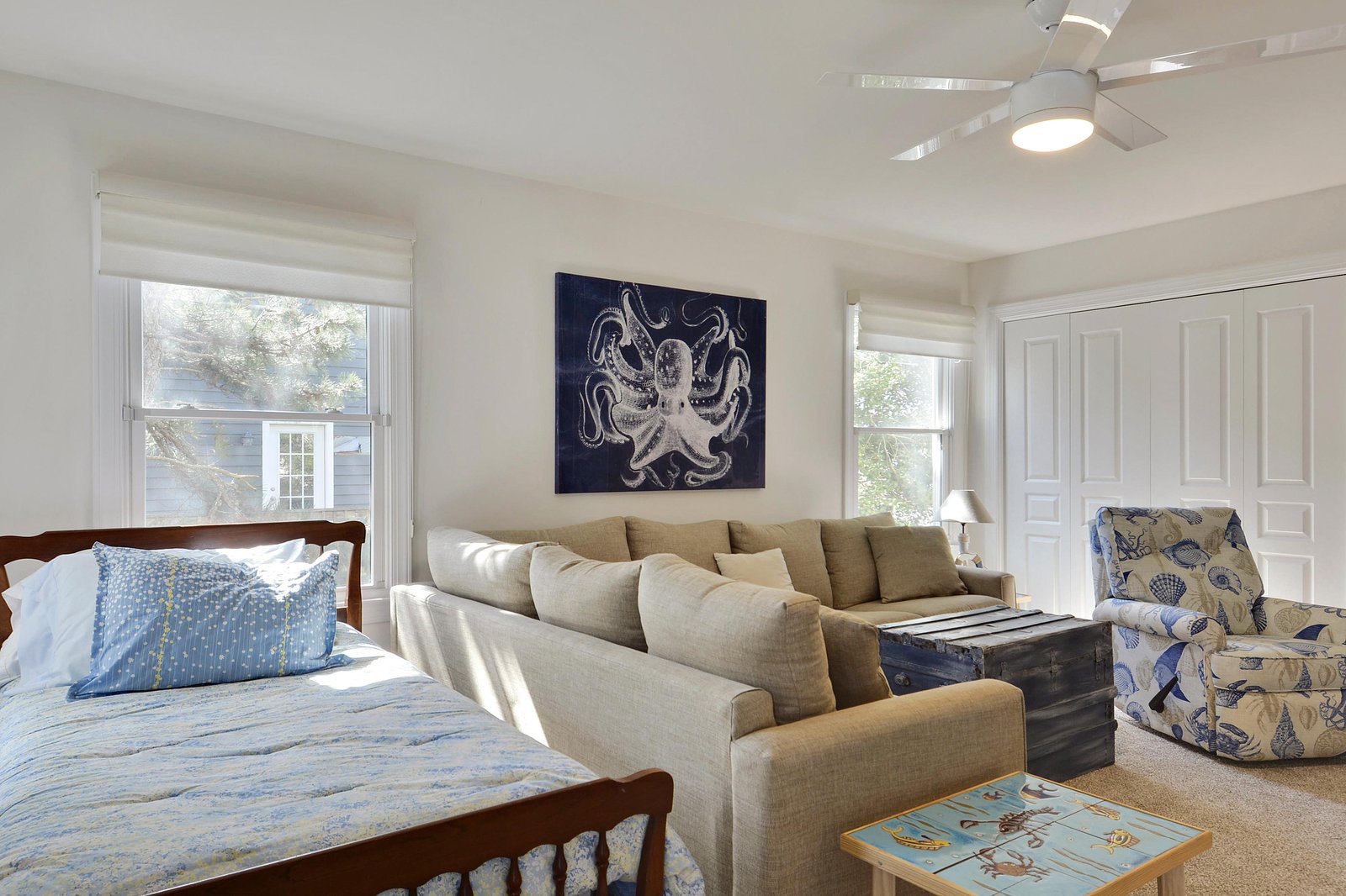 Your bright coastal retreat blends sleeping and lounging space perfectly. Sink into the plush sofa or settle into bed under the ceiling fan—ideal for unwinding after a day of adventure.