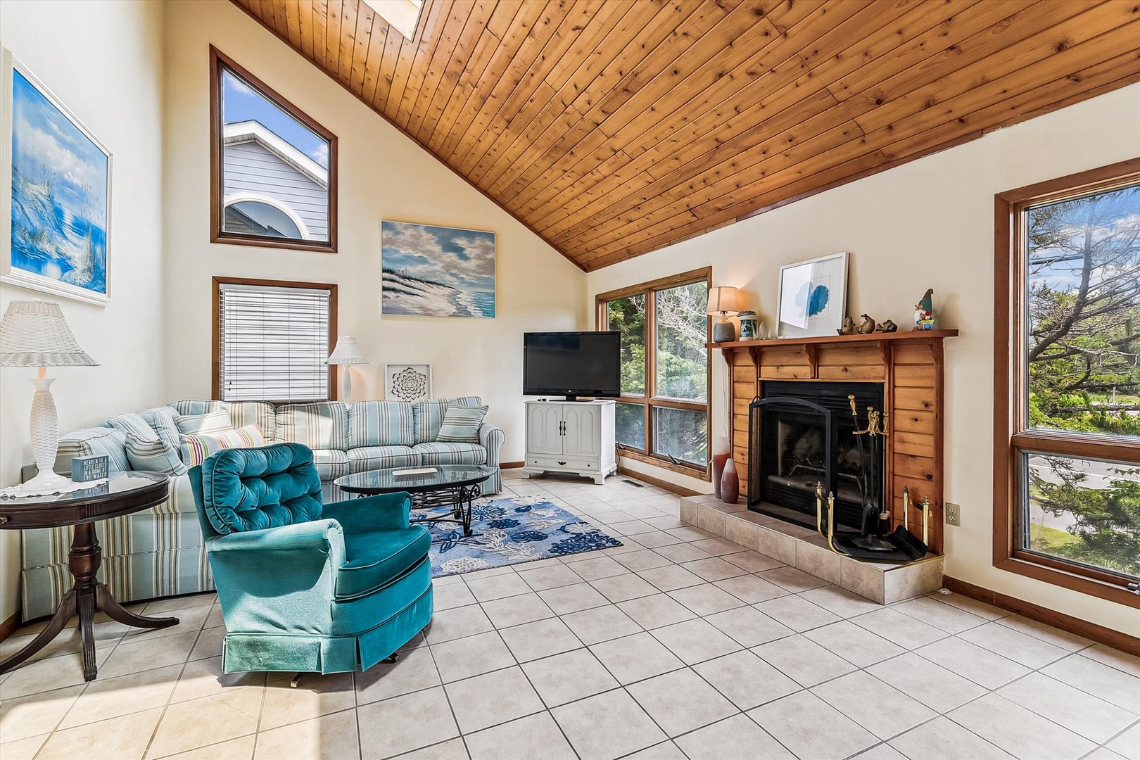 Settle into your spacious living room with vaulted wood ceilings, a cozy fireplace, and large windows framing serene natural views—perfect for unwinding after your day's adventures.