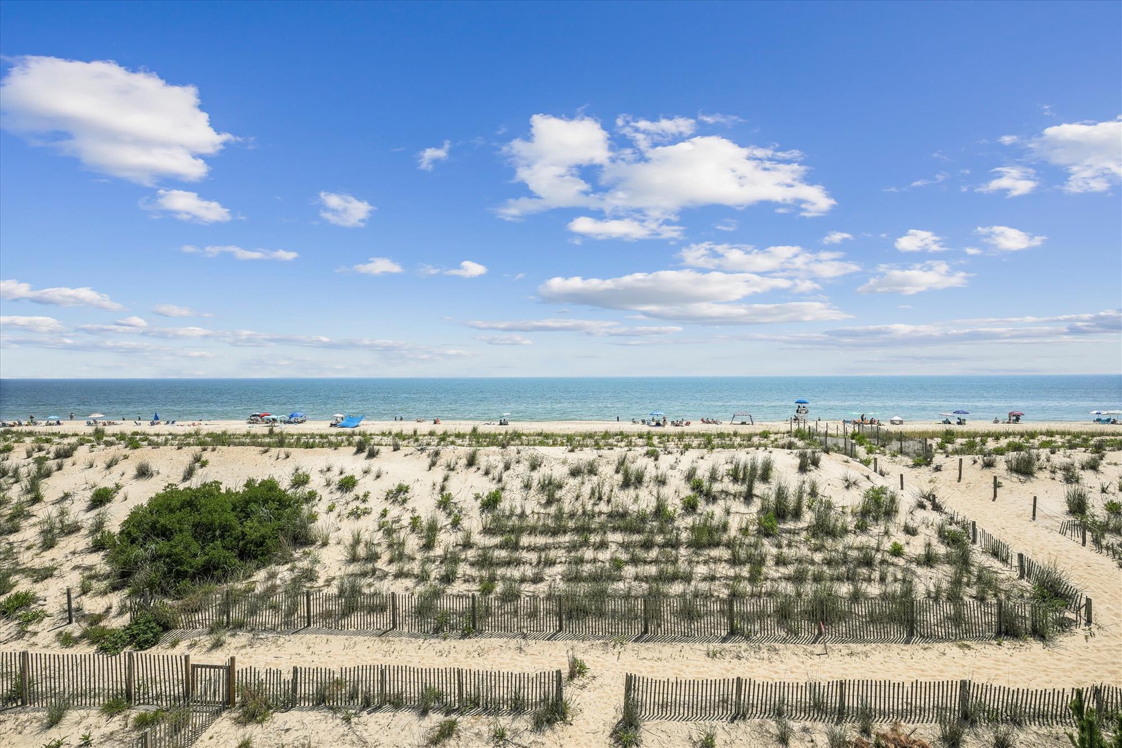The property sits just steps from pristine sandy shores where turquoise waters meet endless blue skies, offering an ideal coastal retreat for beach lovers.