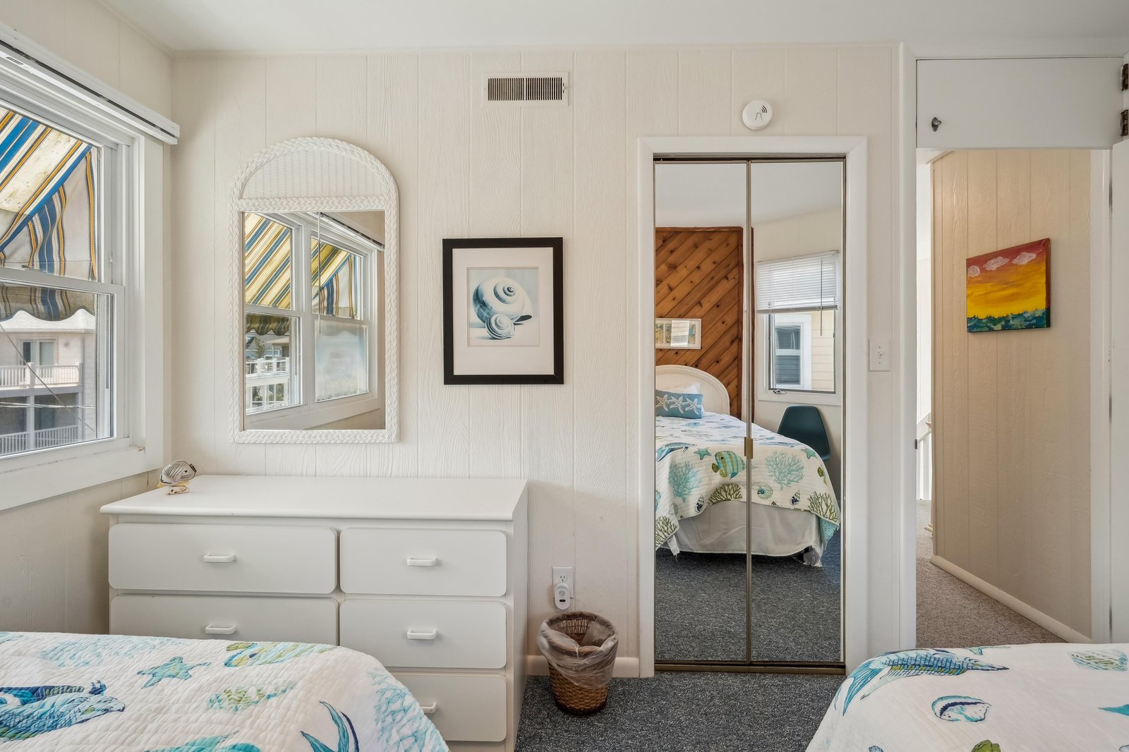Step into your coastal-inspired bedroom, where bright natural light and soft blue accents create a calm, beachy atmosphere perfect for unwinding after a day of adventure.
