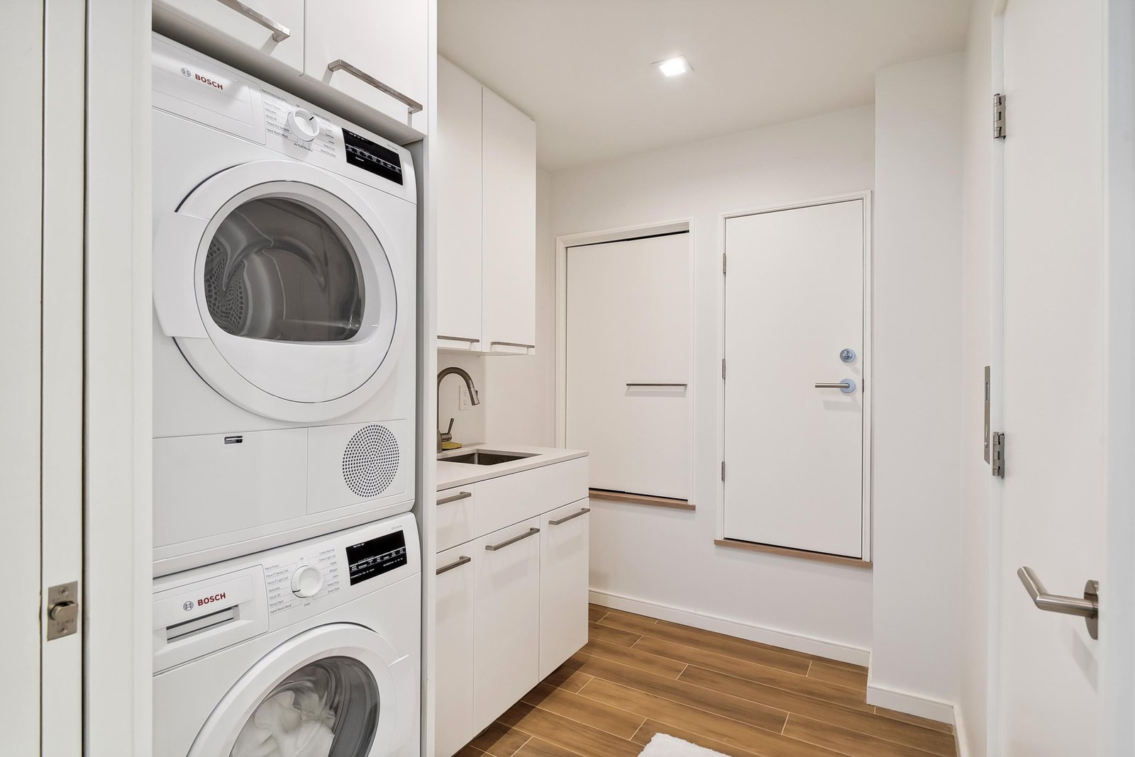 Your in-unit laundry closet features a stacked washer and dryer, plus a compact sink and storage to make laundry day effortless.