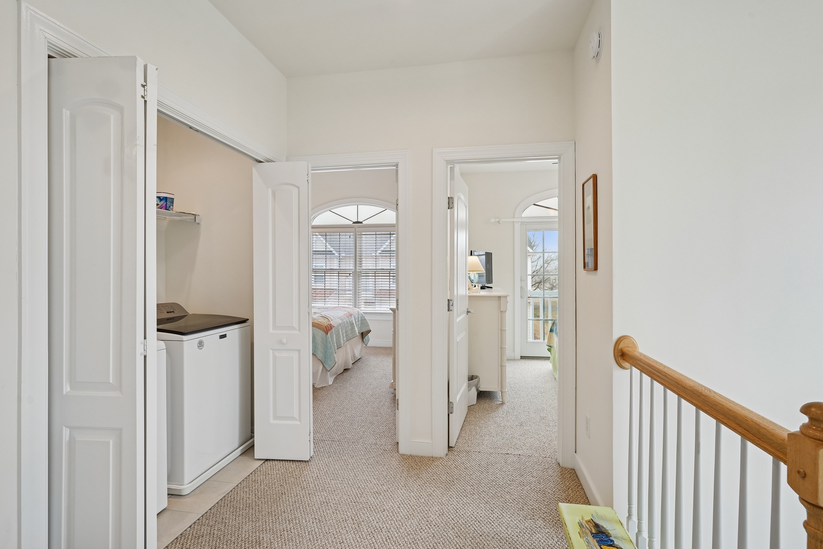 Your private upstairs hallway connects thoughtfully designed spaces, creating a seamless flow between restful bedrooms and modern conveniences.