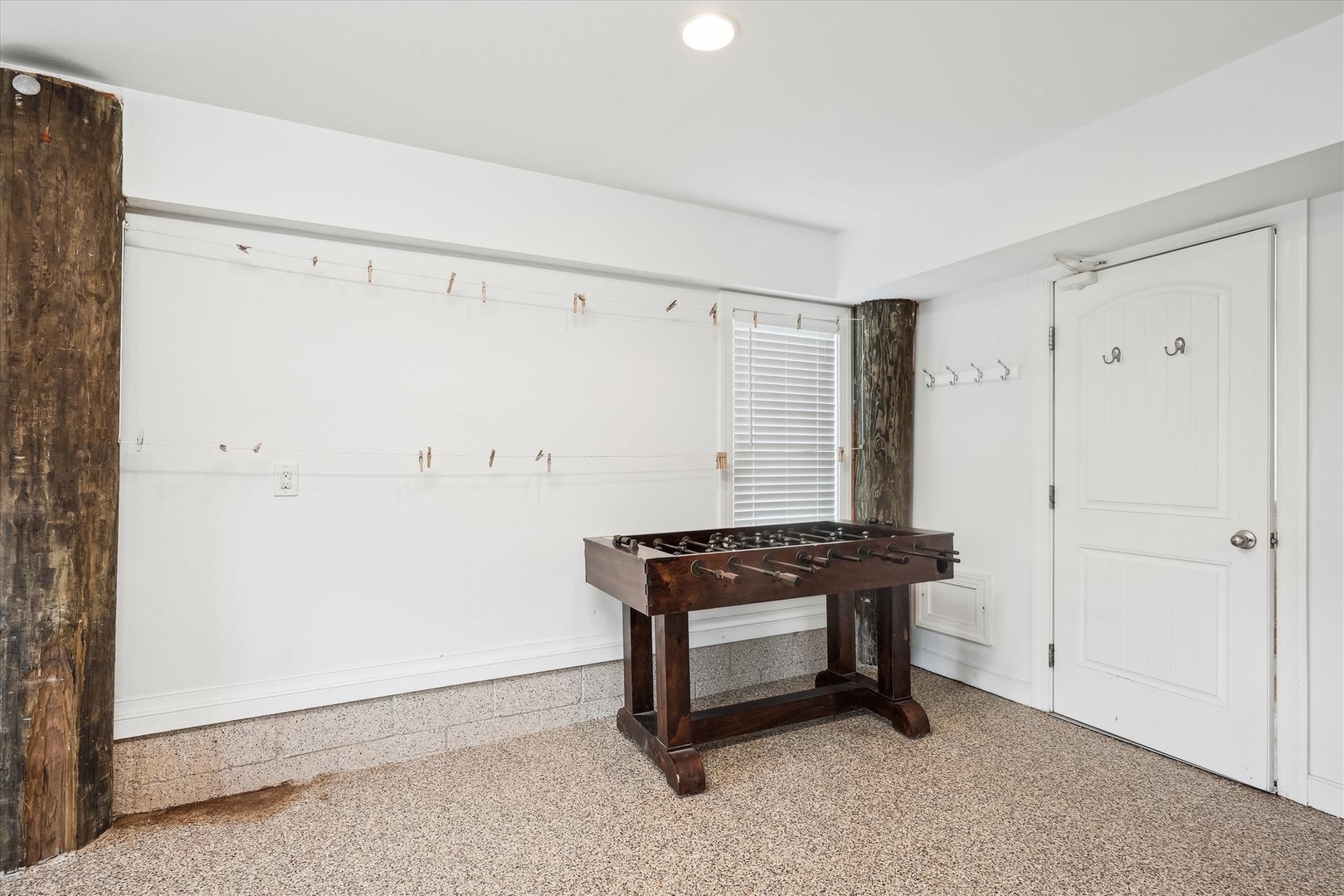 Challenge your friends to a spirited match at the foosball table in this bright, dedicated game space—your personal entertainment zone awaits.
