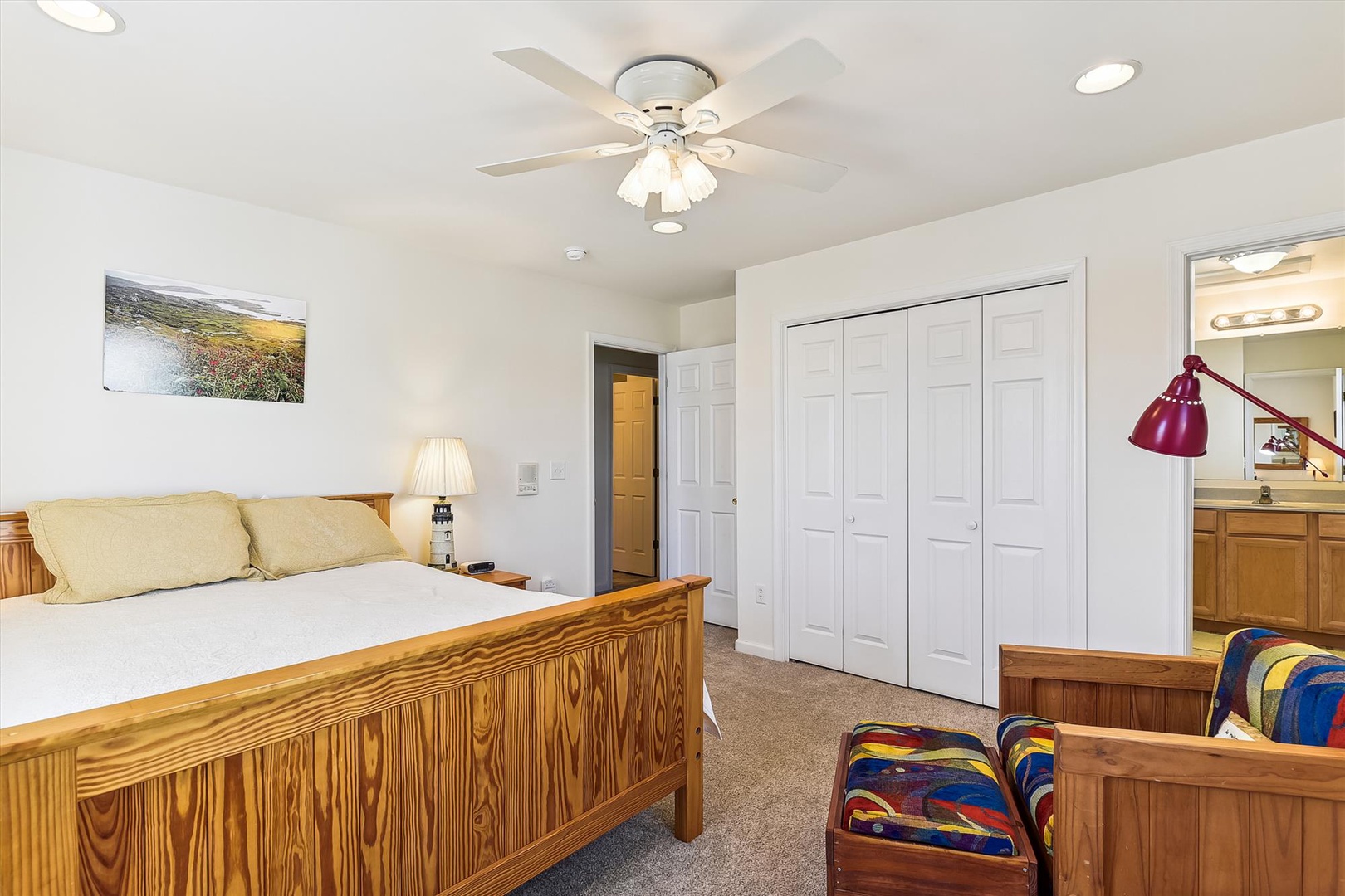 Relax in your spacious bedroom featuring warm wood furnishings, soft carpeting, and a ceiling fan to keep you comfortable. Generous closet space and an en-suite bathroom ensure your convenience.