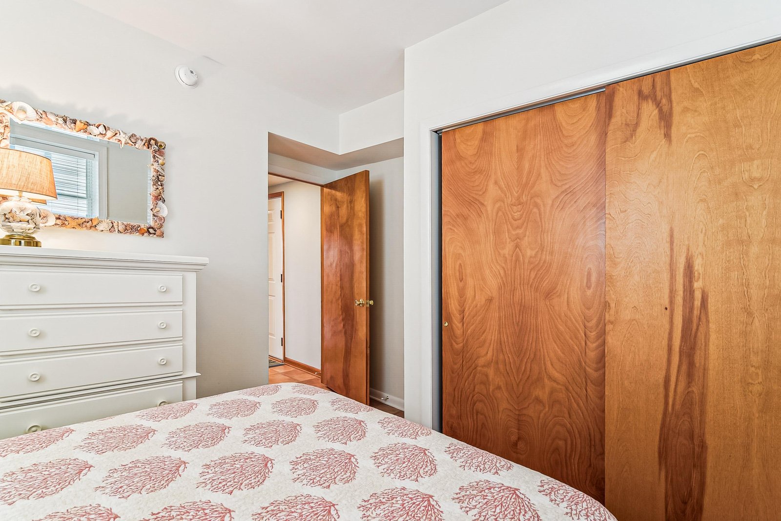Curl up in this cozy bedroom with its soft bedding and ample storage for your belongings. The warm wood tones and clean white accents create a peaceful retreat after a day of adventure.