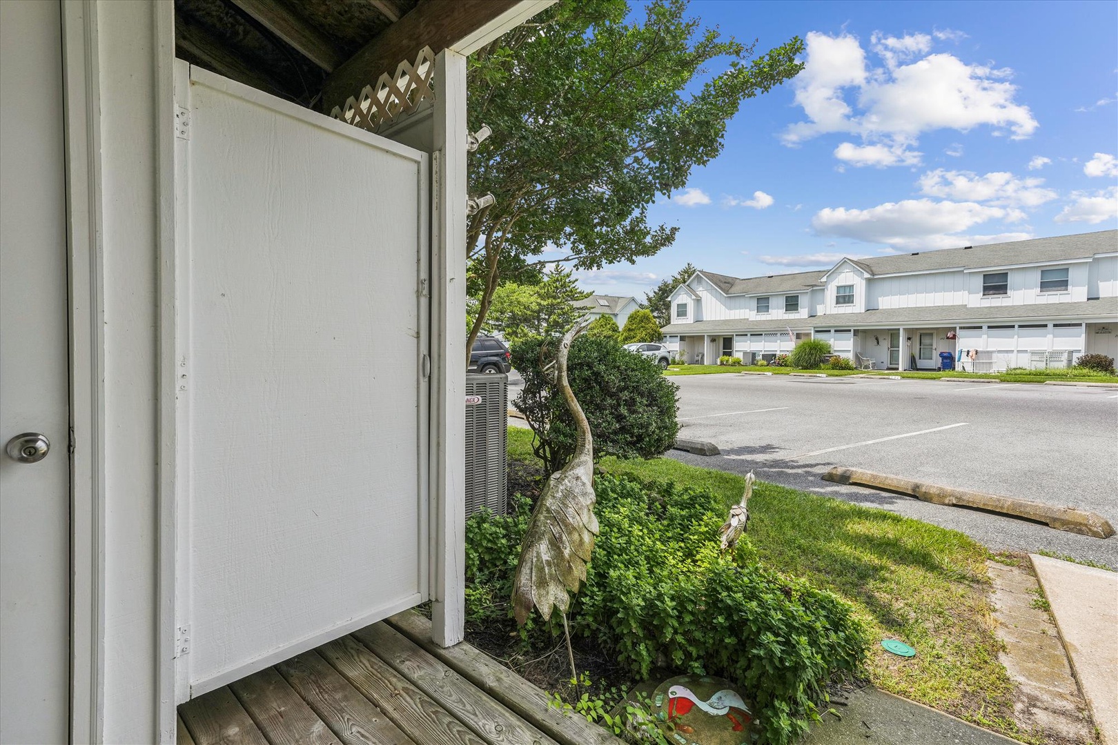 Your private entrance opens to a peaceful residential street with convenient parking and mature landscaping in this quiet neighborhood setting.