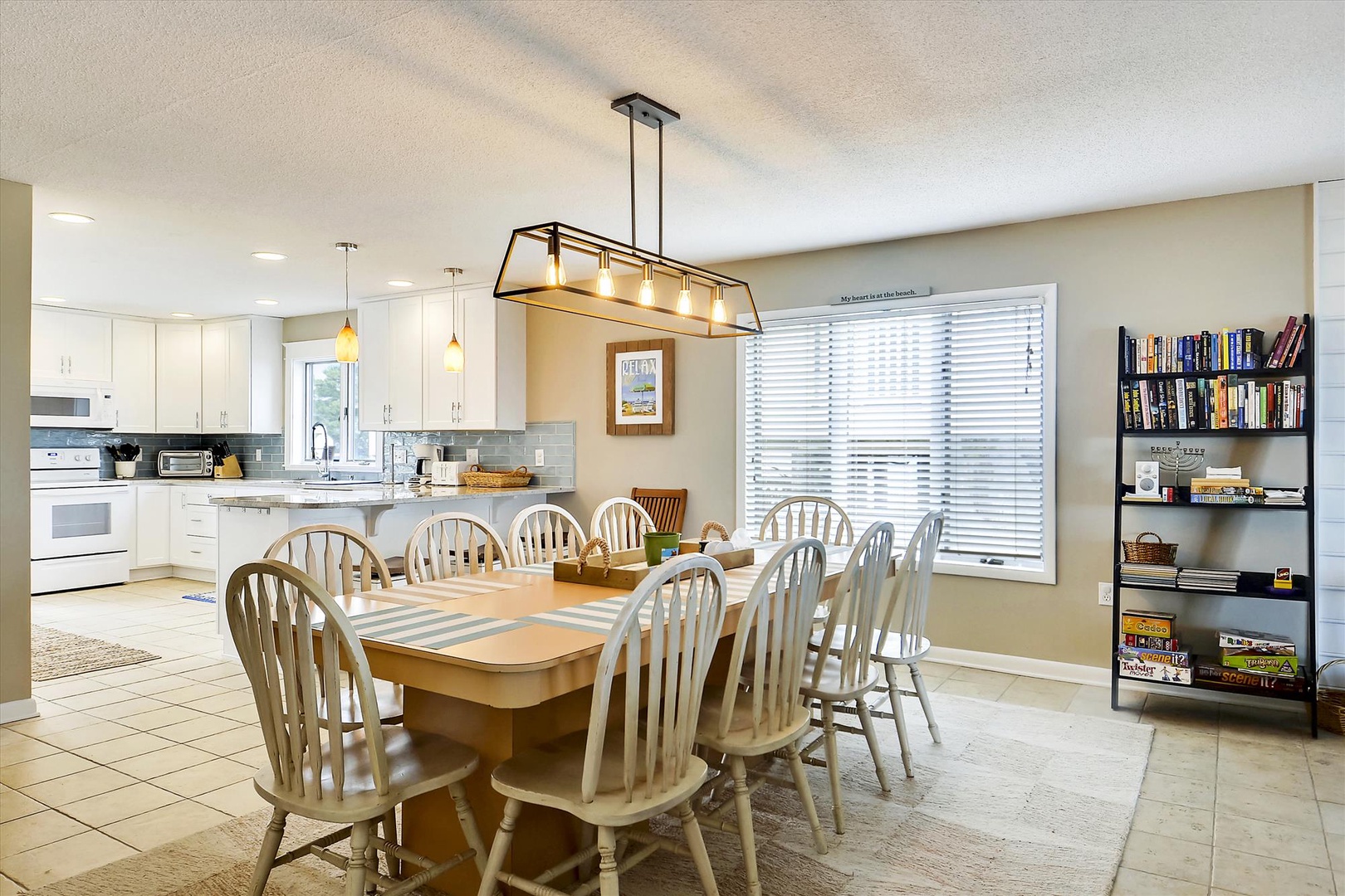 Picture yourself gathered around this welcoming dining table, sharing laughter and meals with your group. The open kitchen and bright, airy space make every moment together feel effortlessly relaxed and connected.