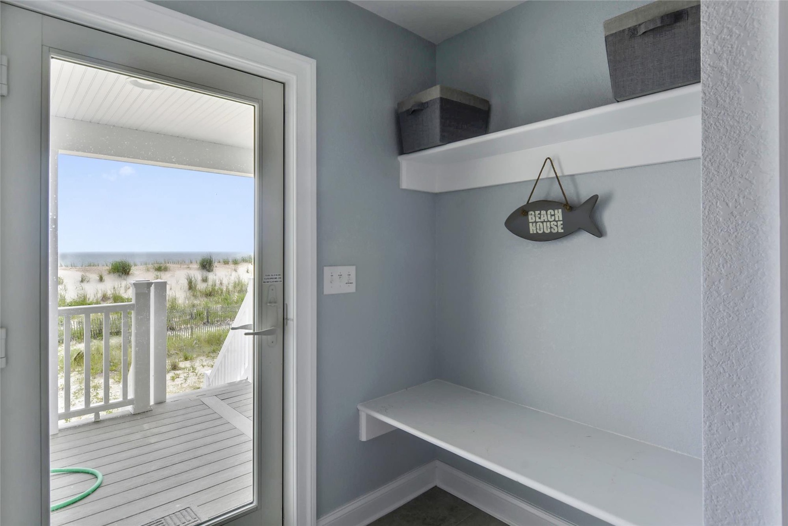Your personal beach nook awaits—organized storage and a built-in bench make coming and going from the sand effortless, with coastal breezes and ocean views just steps away.